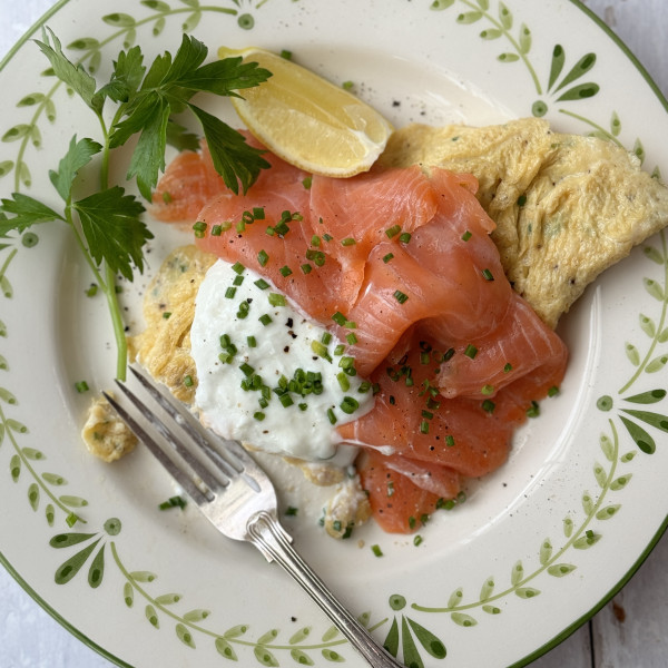 salmon omelette on white plate with fork