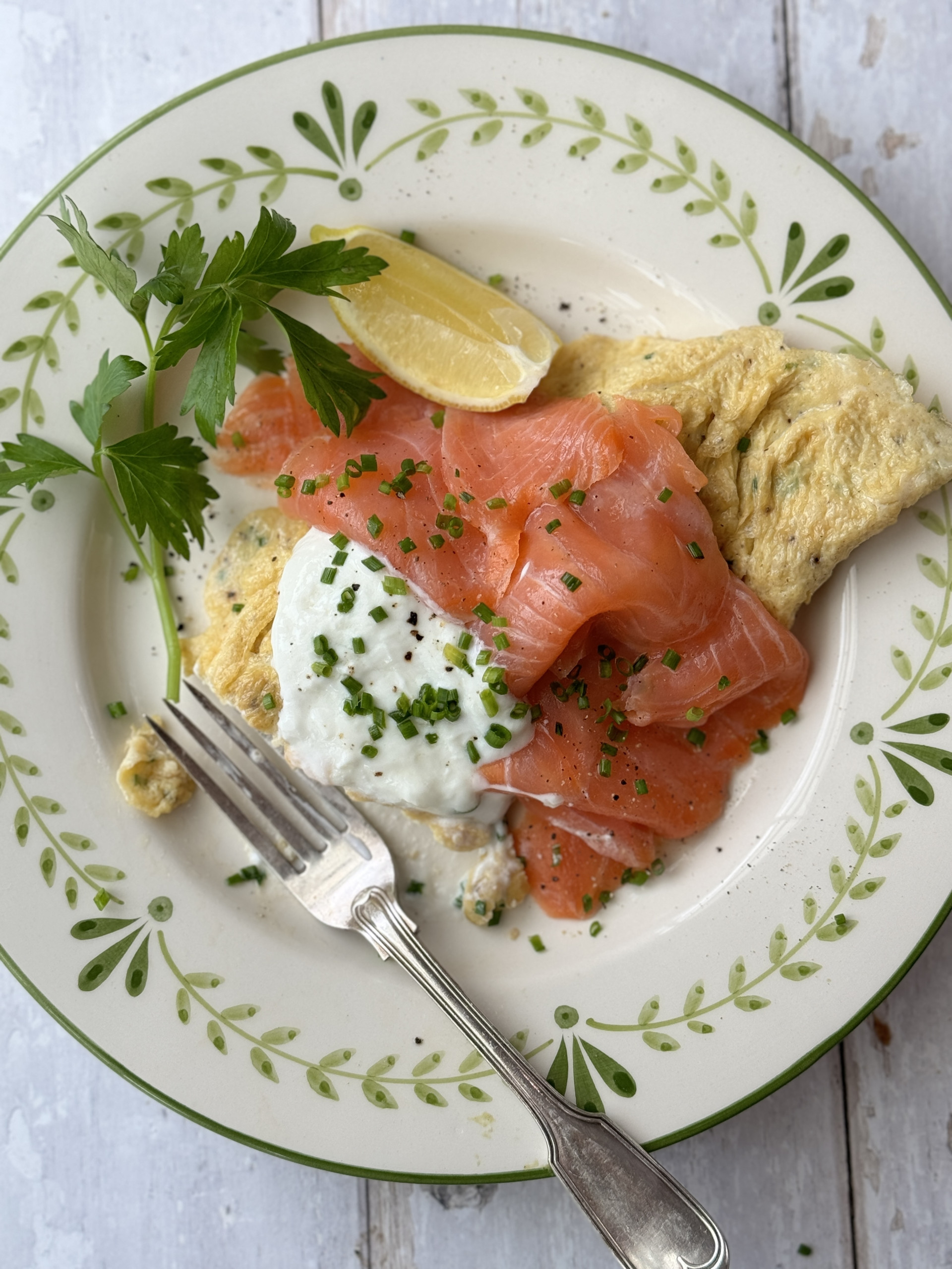 salmon omelette on white plate with fork