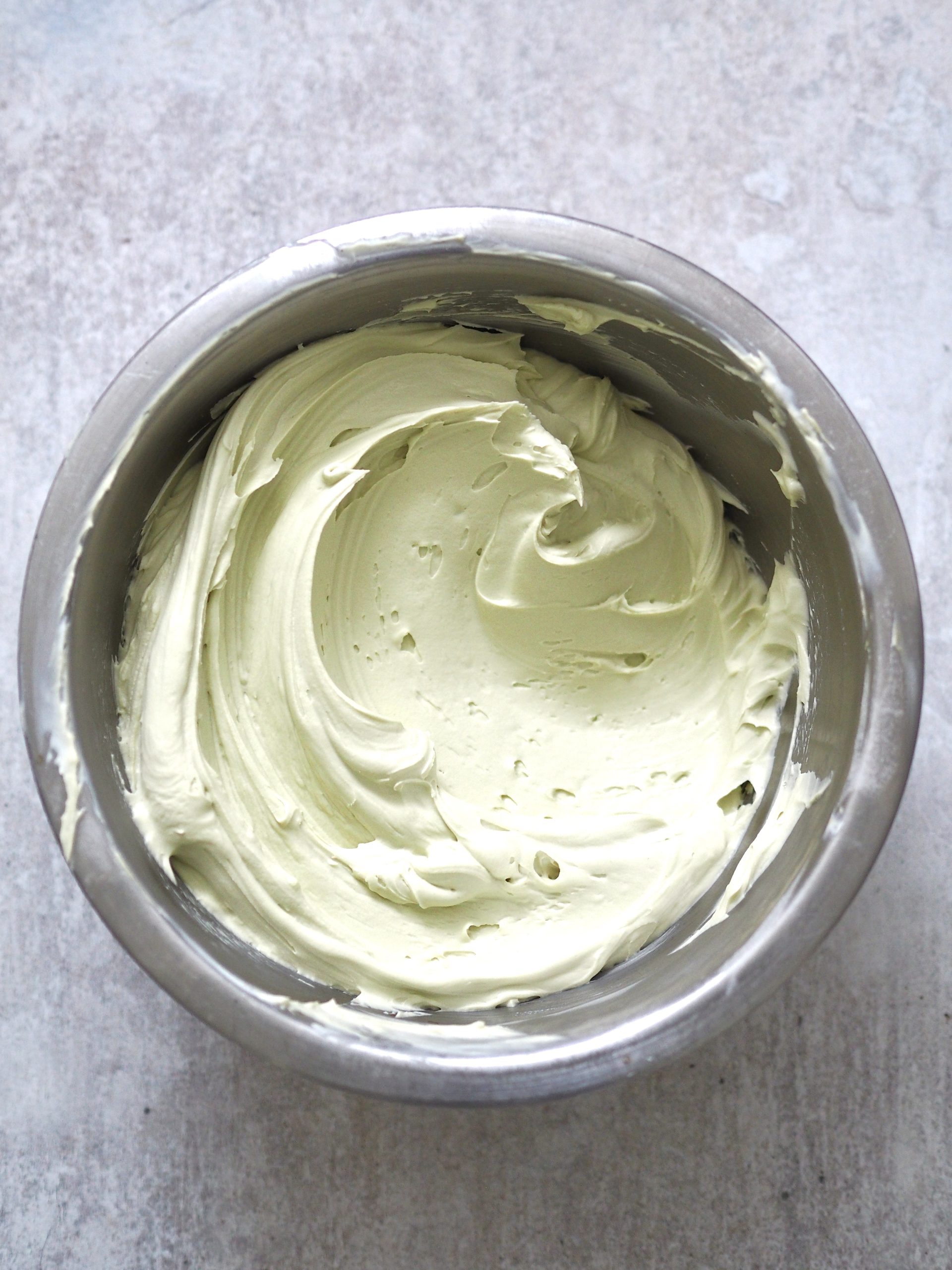 pistachio whipped cream in metal bowl