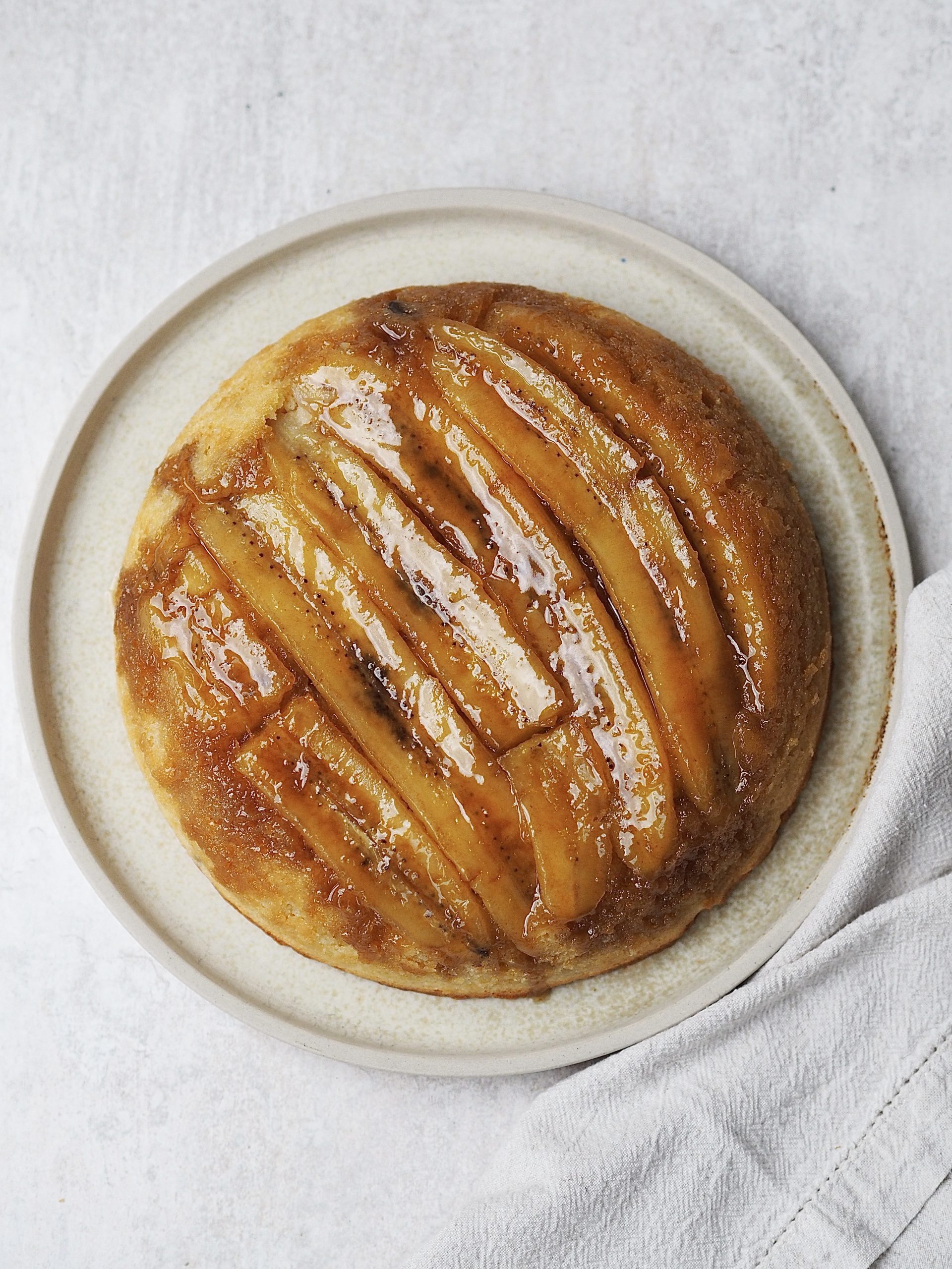 upside down banana cake on a white plate