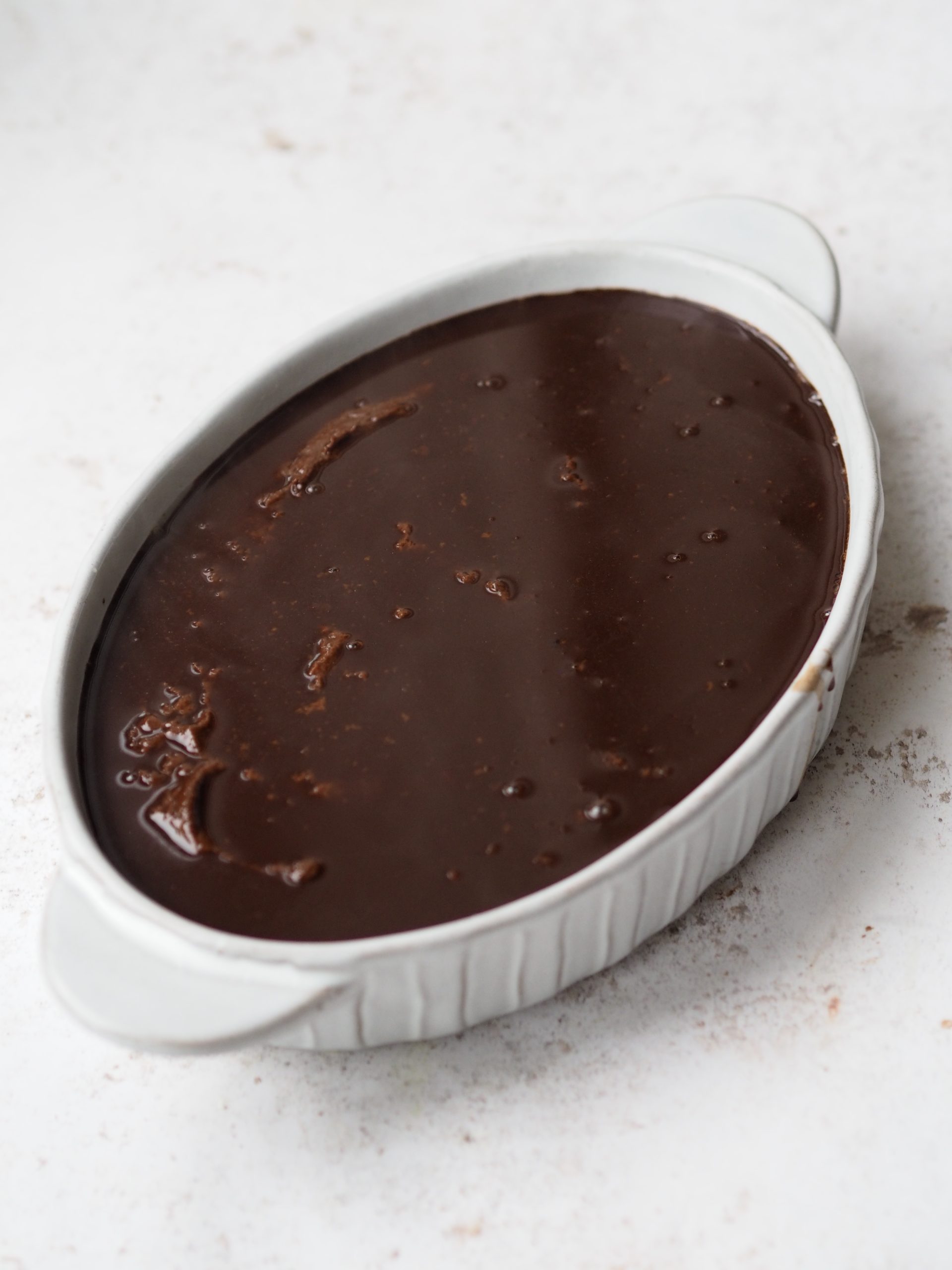 Self Saucing Chocolate Pudding in a white baking dish