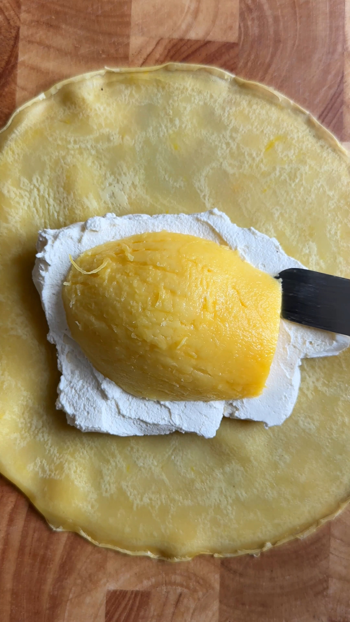 half a mango on whipped cream in pancake