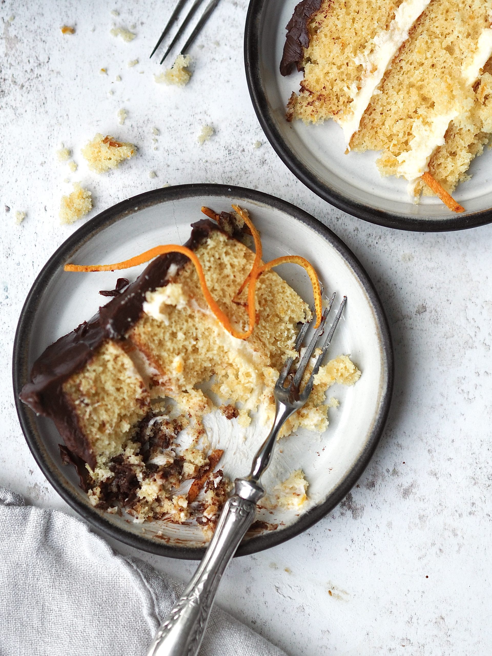 jaffa cake cake with an eaten slice removed on a black plate