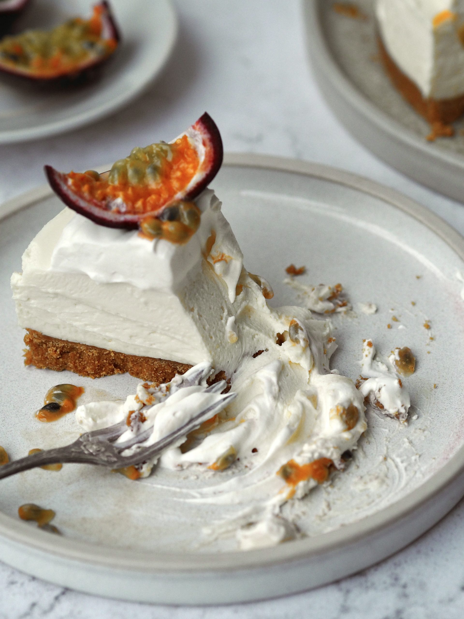 White Chocolate and Passion Fruit Cheesecake on a white plate in slices