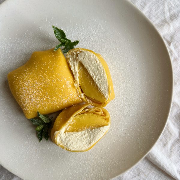 folded mango pancakes on a white place