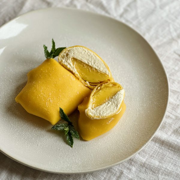 folded mango pancakes on a white place