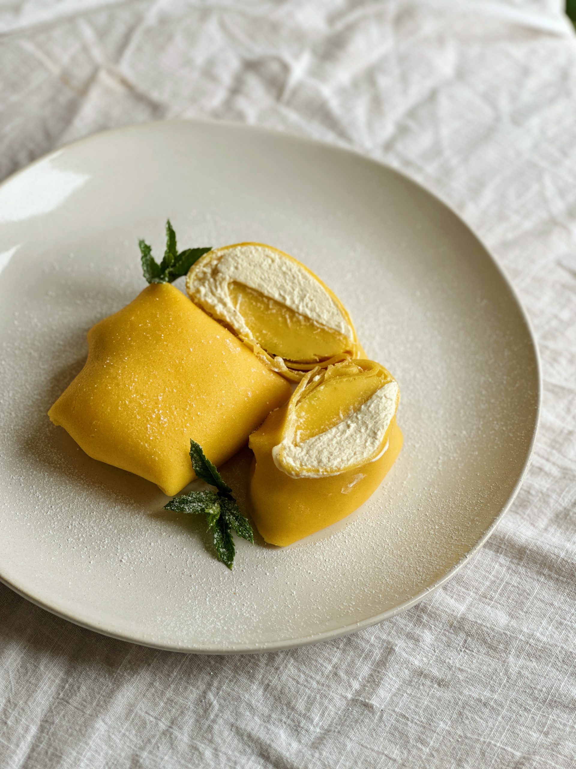 folded mango pancakes on a white place