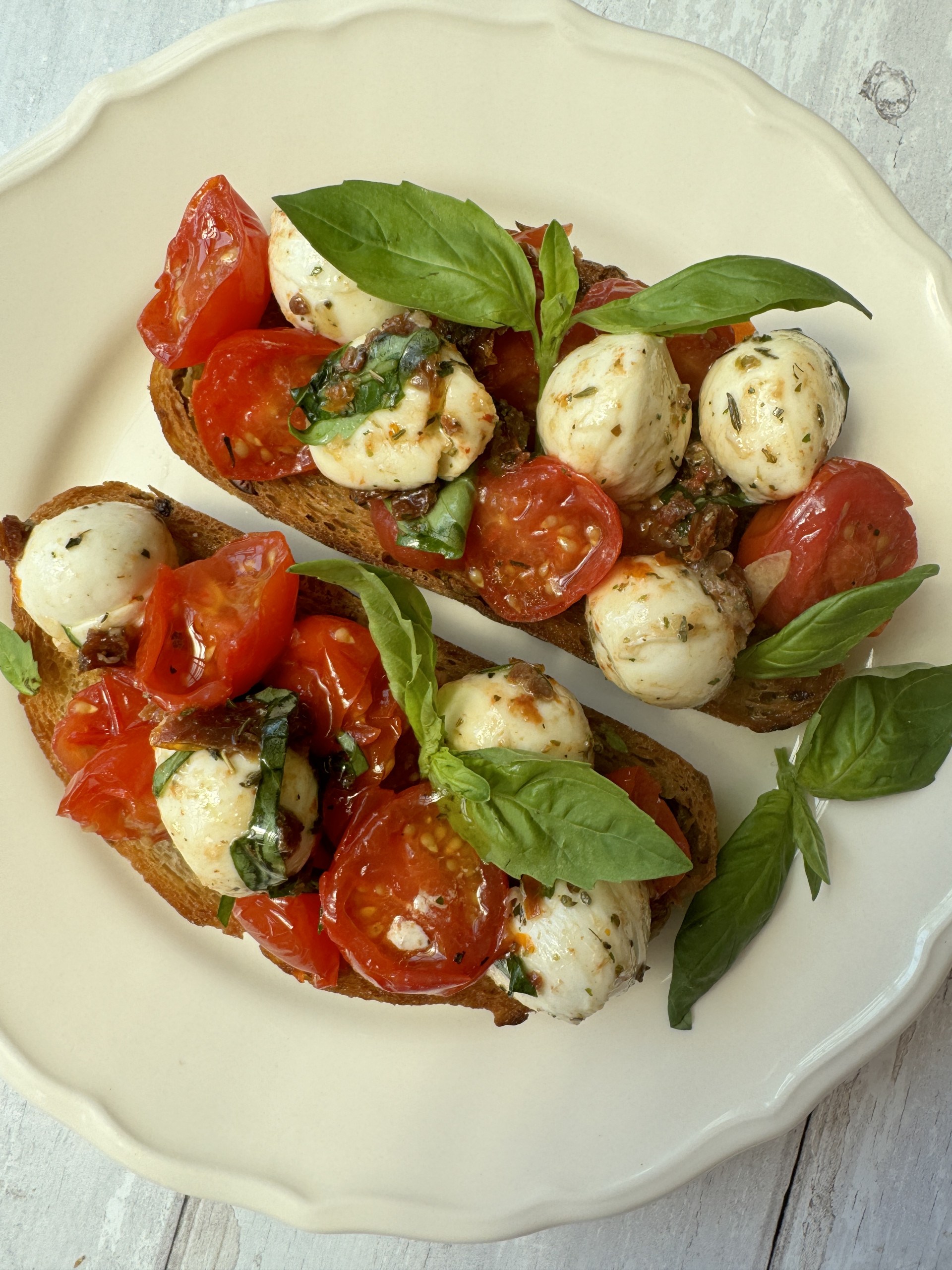 marinated mozzarella ball crostini on white plate