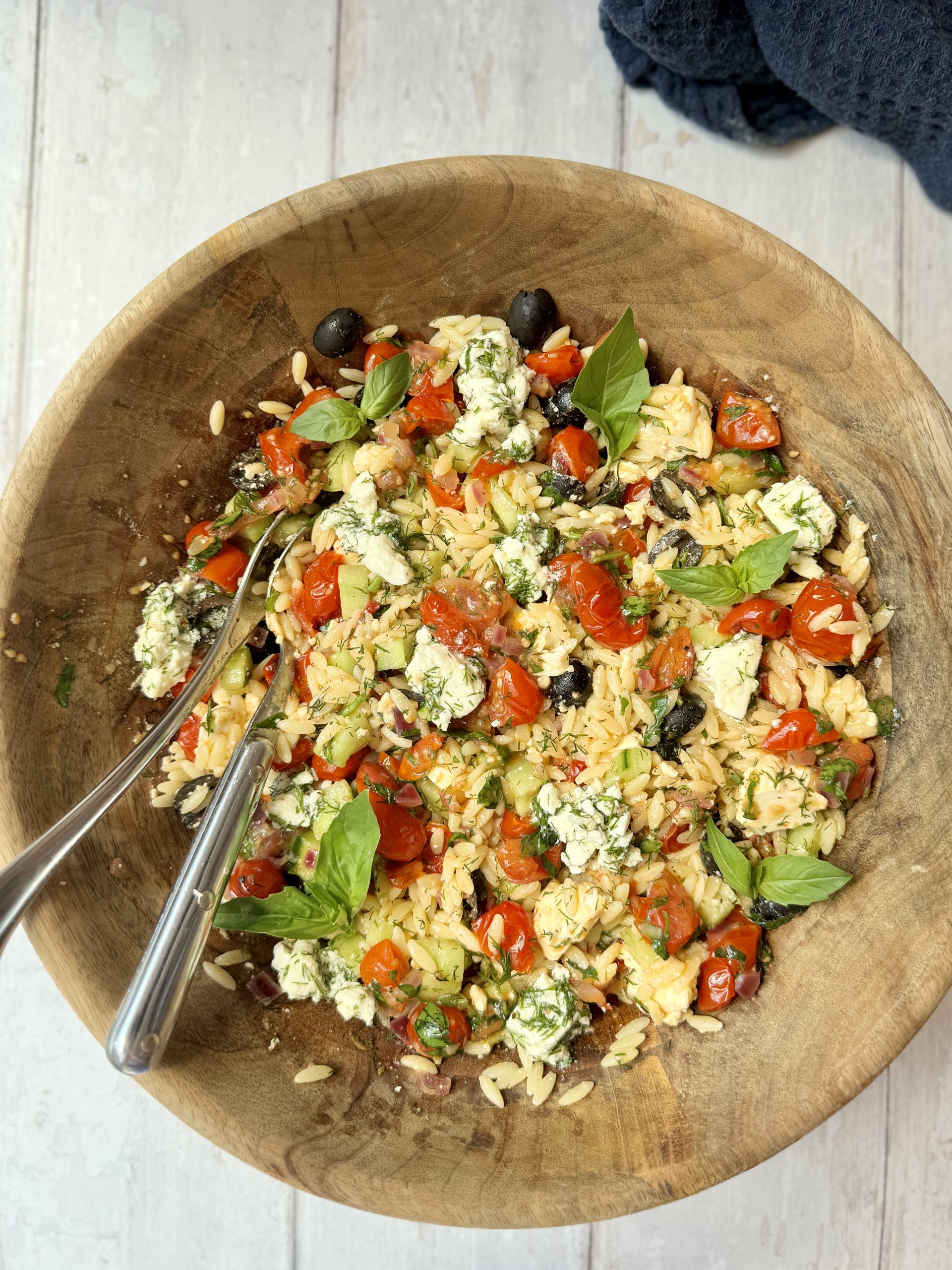 greek pasta salad in wooden bowl