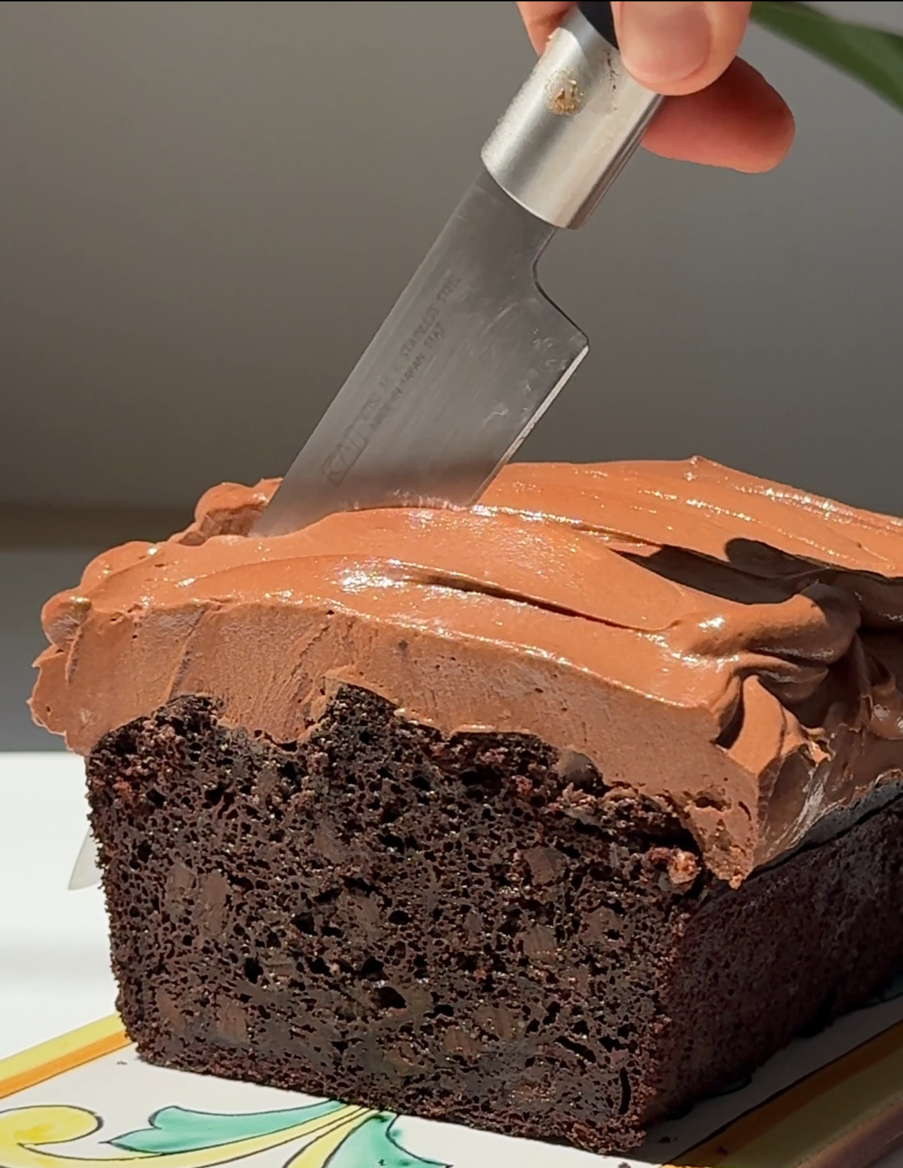 chocolate courgette cake being sliced.