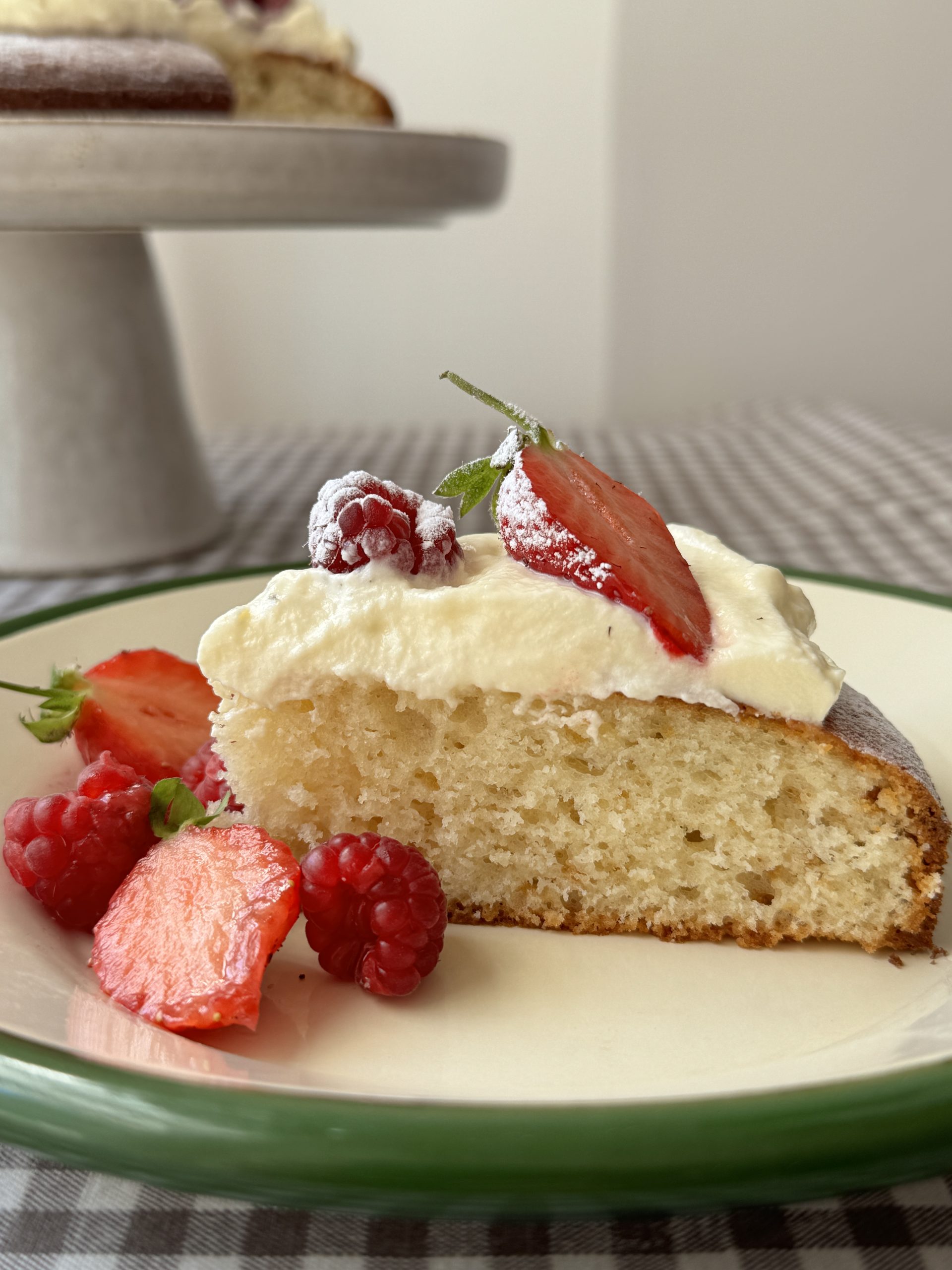 Gâteau au yaourt slice with strawberries on white plate