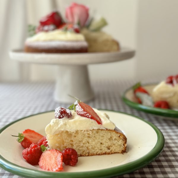 Gâteau au yaourt slice with cake behind on cake stand