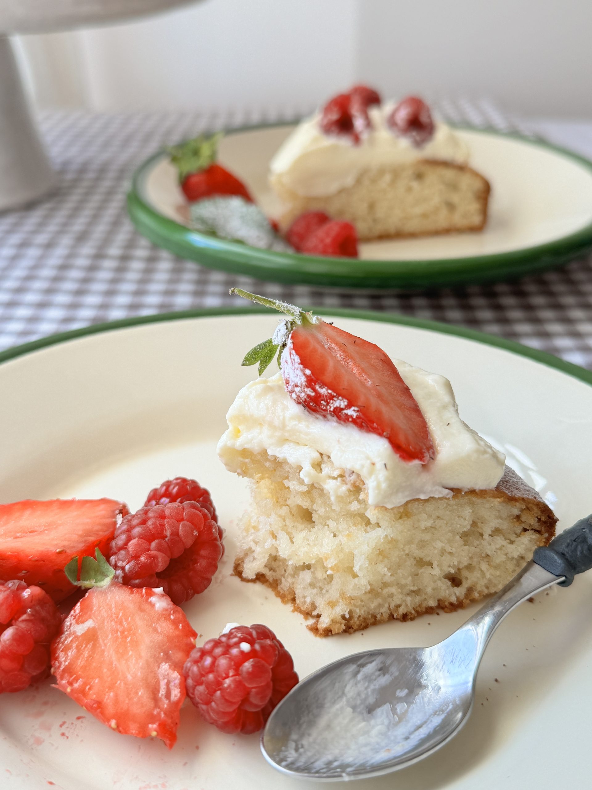 Gâteau au yaourt slice with strawberries on white plate