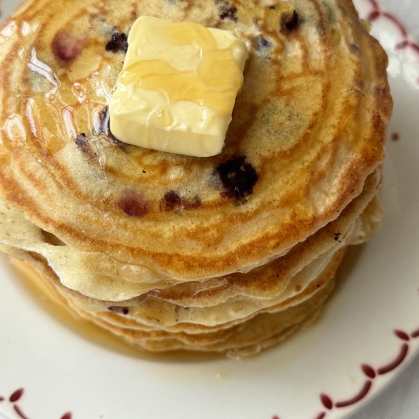 a stack of pancakes with no baking powder on a white plate