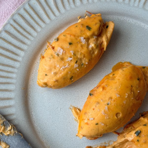 quenelles of tomato butter on a grey plate