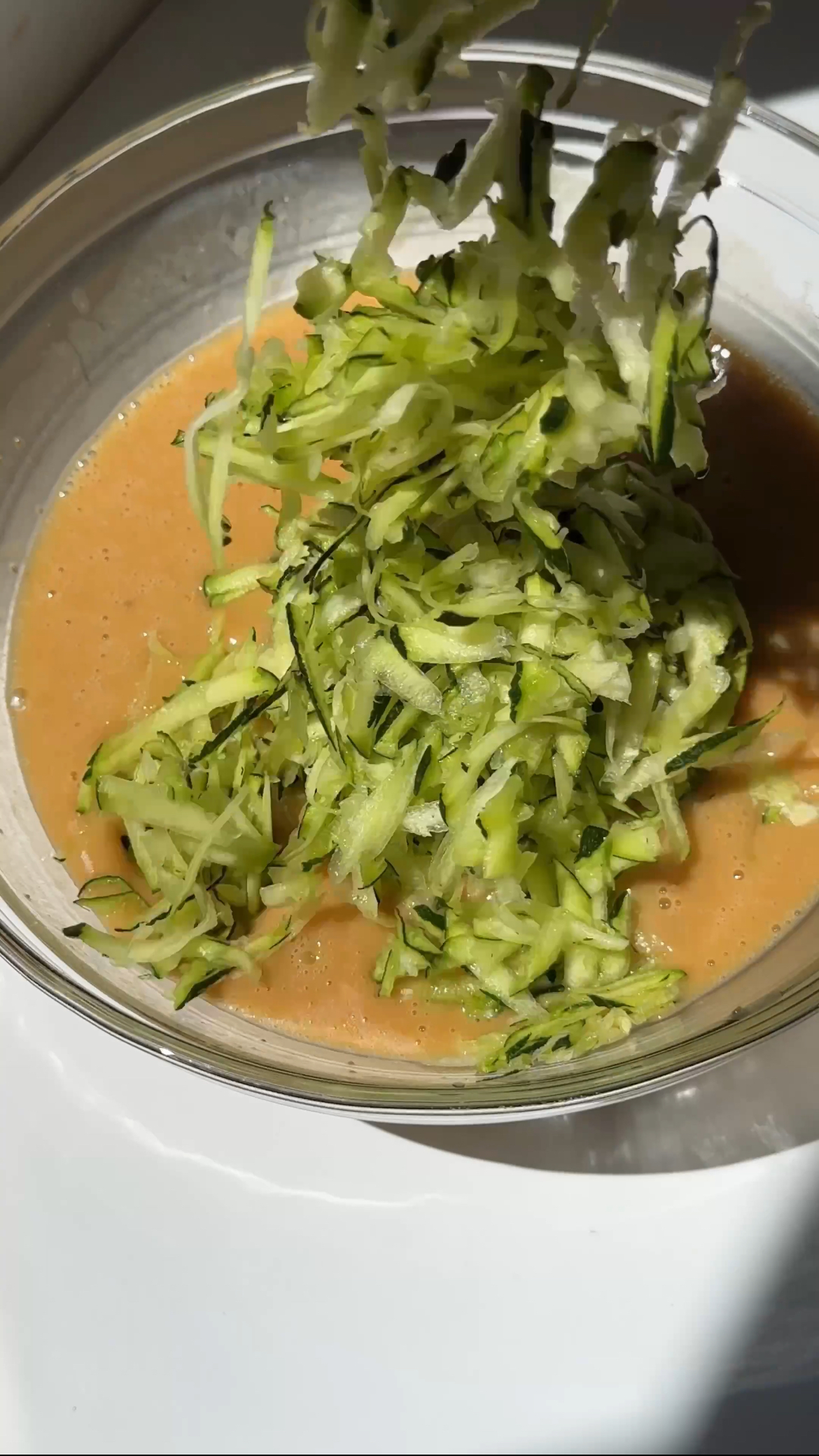 adding courgette to cake batter