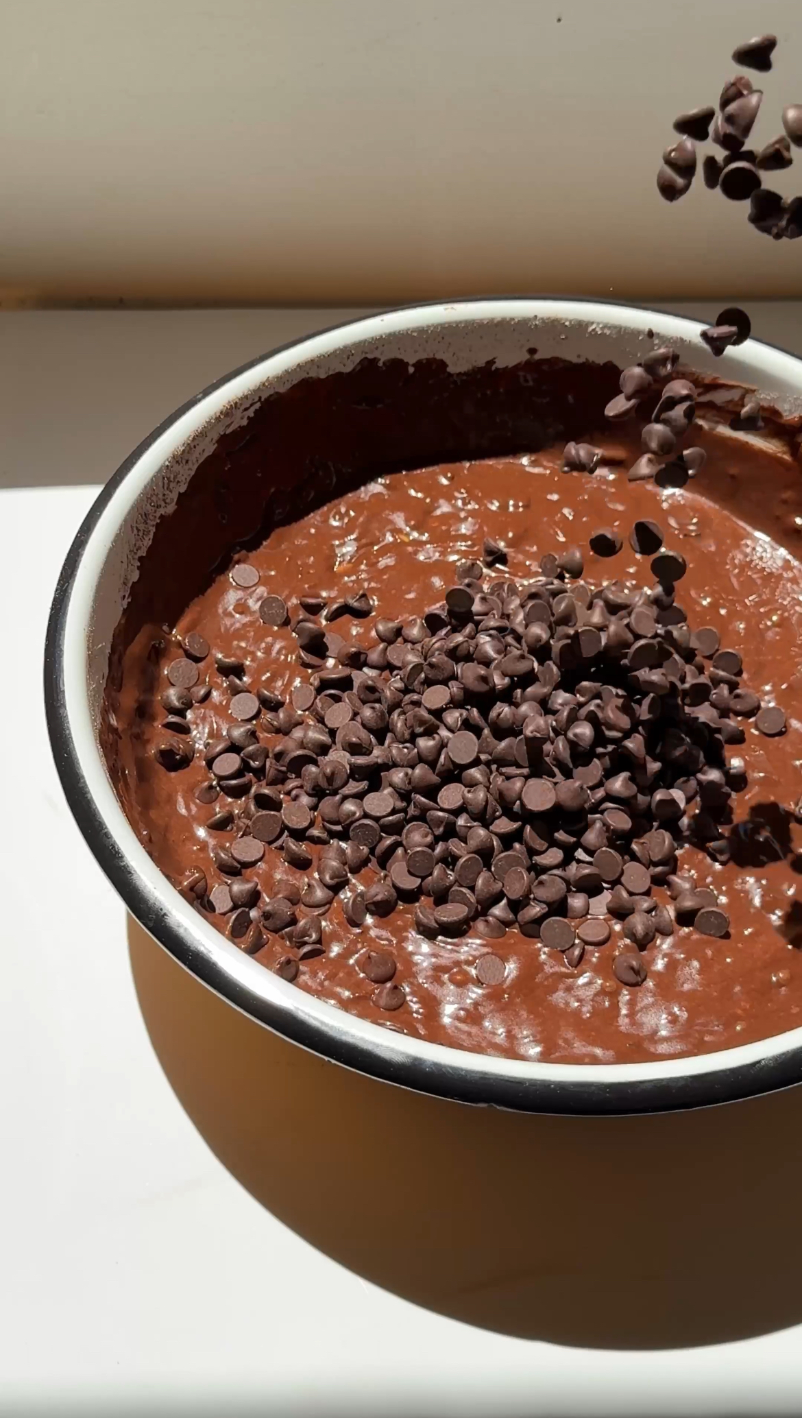 adding chocolate chunks to chocolate cake mix