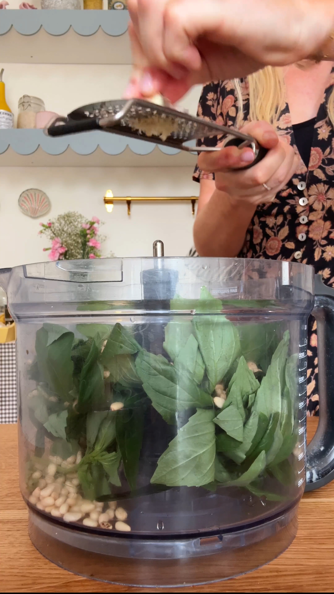 adding garlic to the food processor for pesto