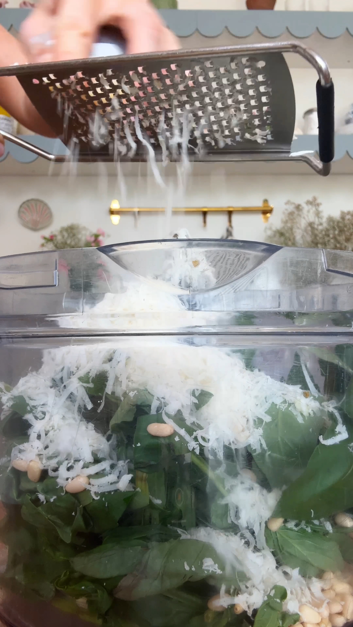 adding parmesan to the food processor for pesto