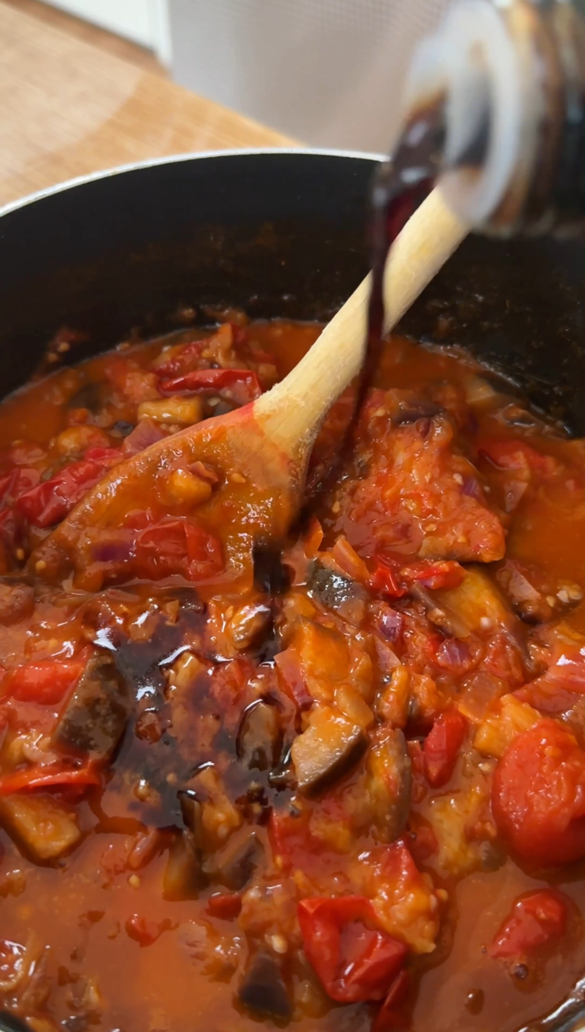 adding balsamic vinegar to the norma sauce