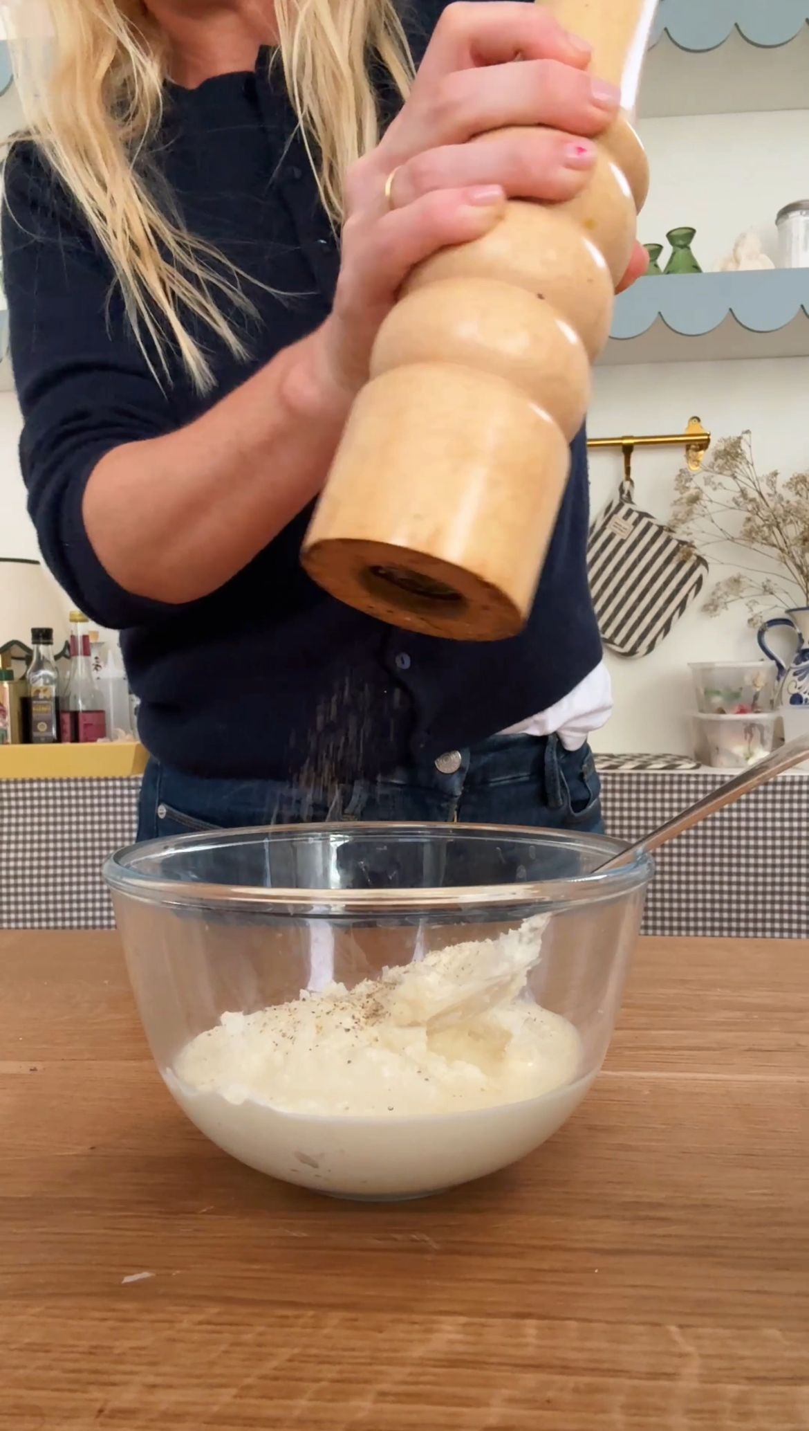 adding pepper to creamy topping