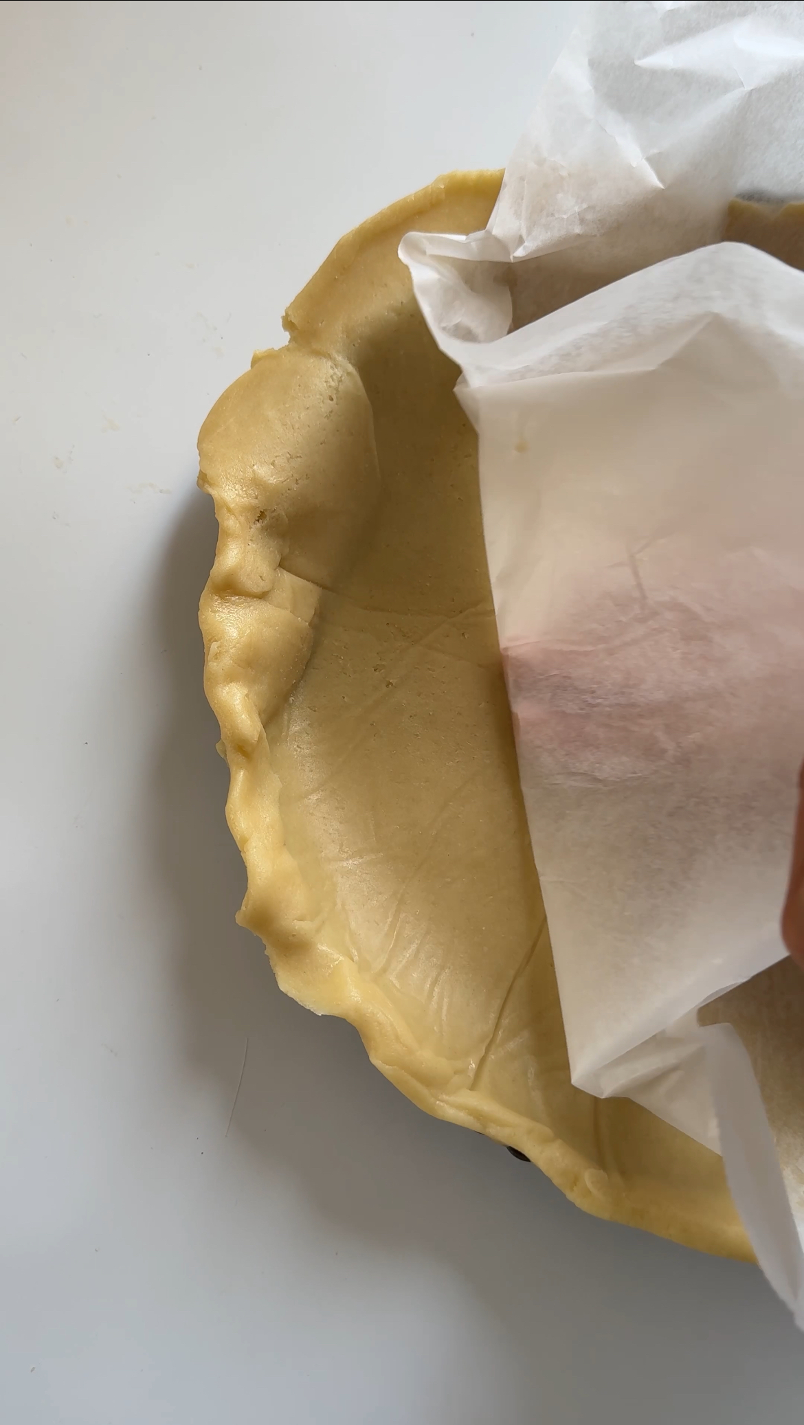 laying pastry into pie tin