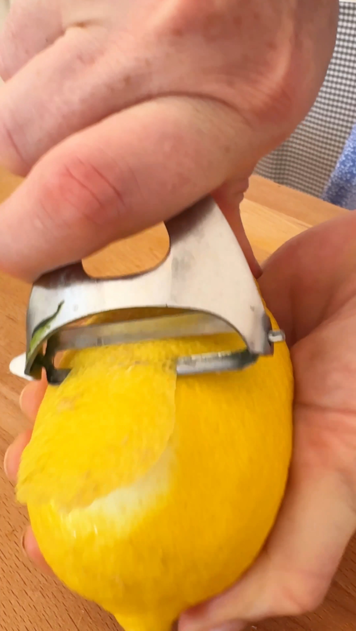 peeling the lemon for the rind 