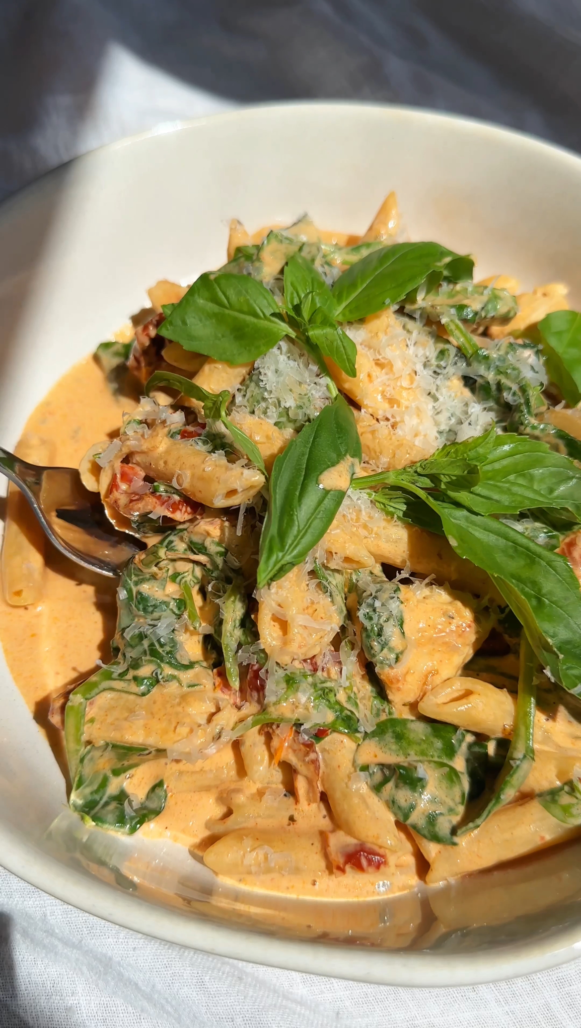 MARRY ME PASTA IN BOWL WITH BASIL ON TOP