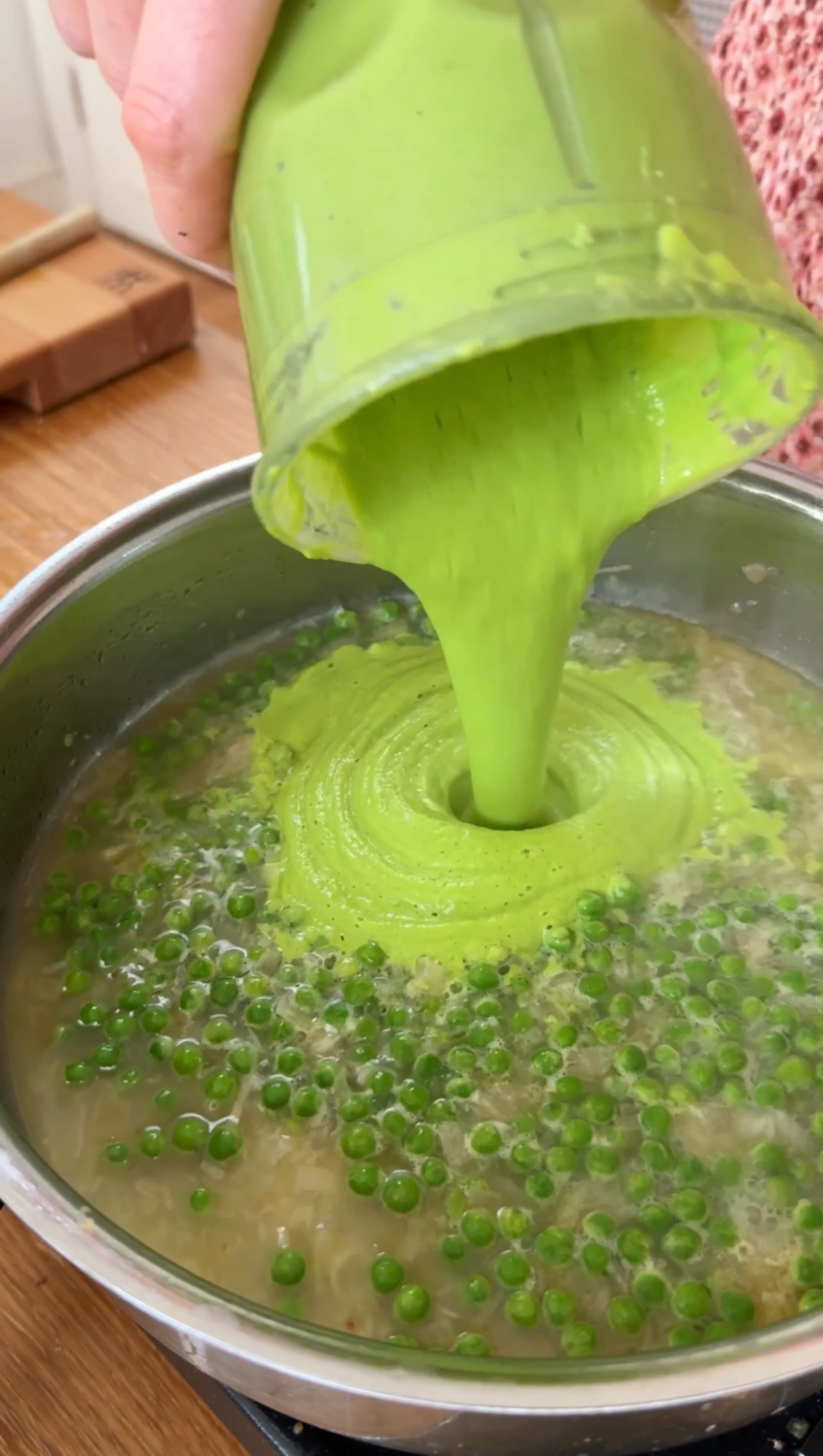 adding the blended pea mixture to the pasta