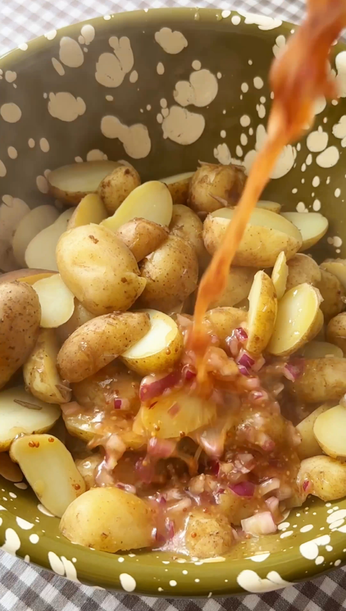 adding dressing to potatoes