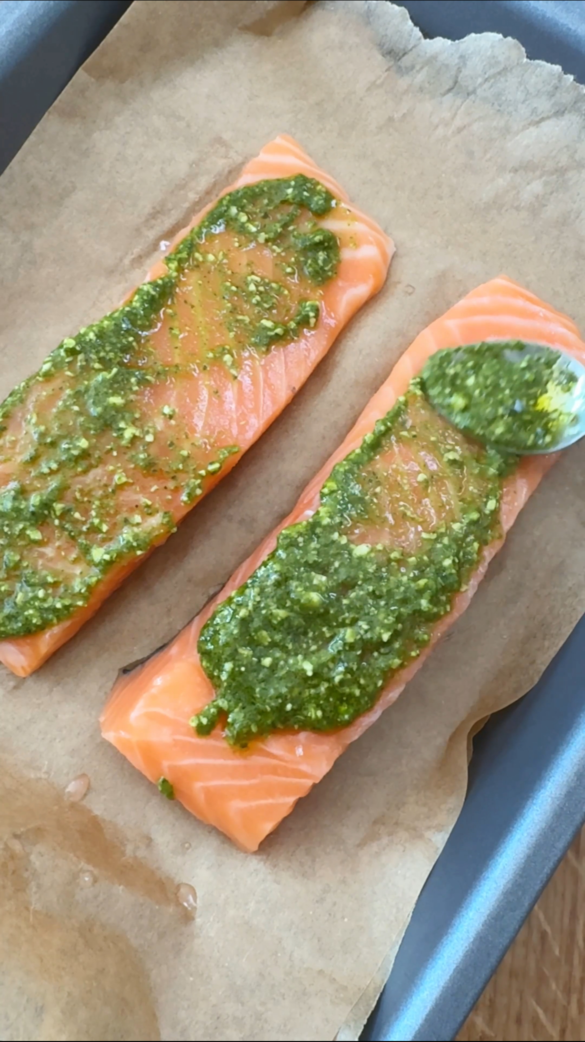 adding pesto to the salmon