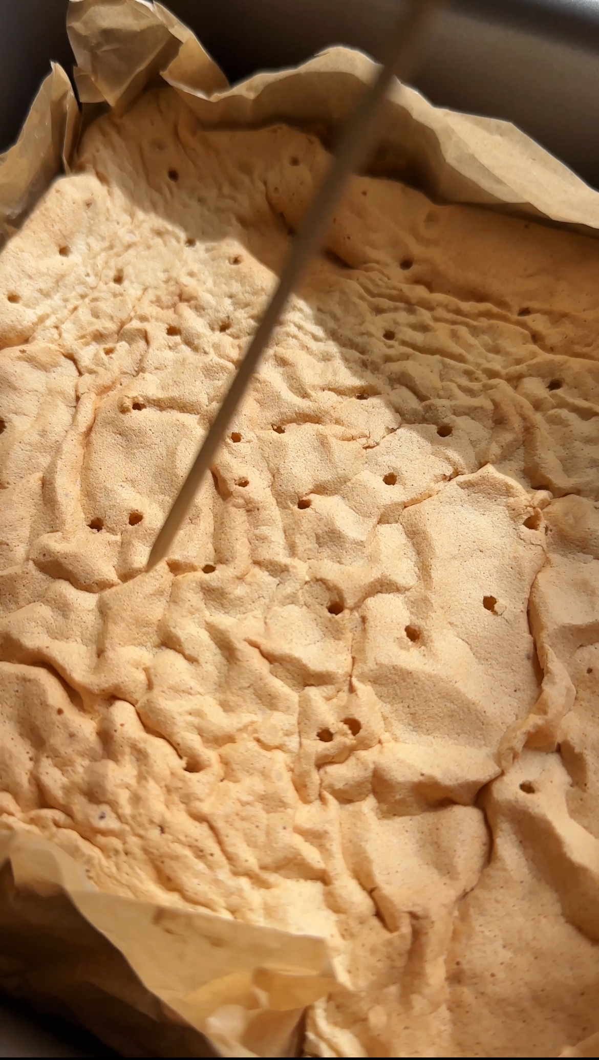 poking holes in the tiramisu tres leches cake