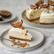 White Chocolate and Passion Fruit Cheesecake on a white plate in slices.