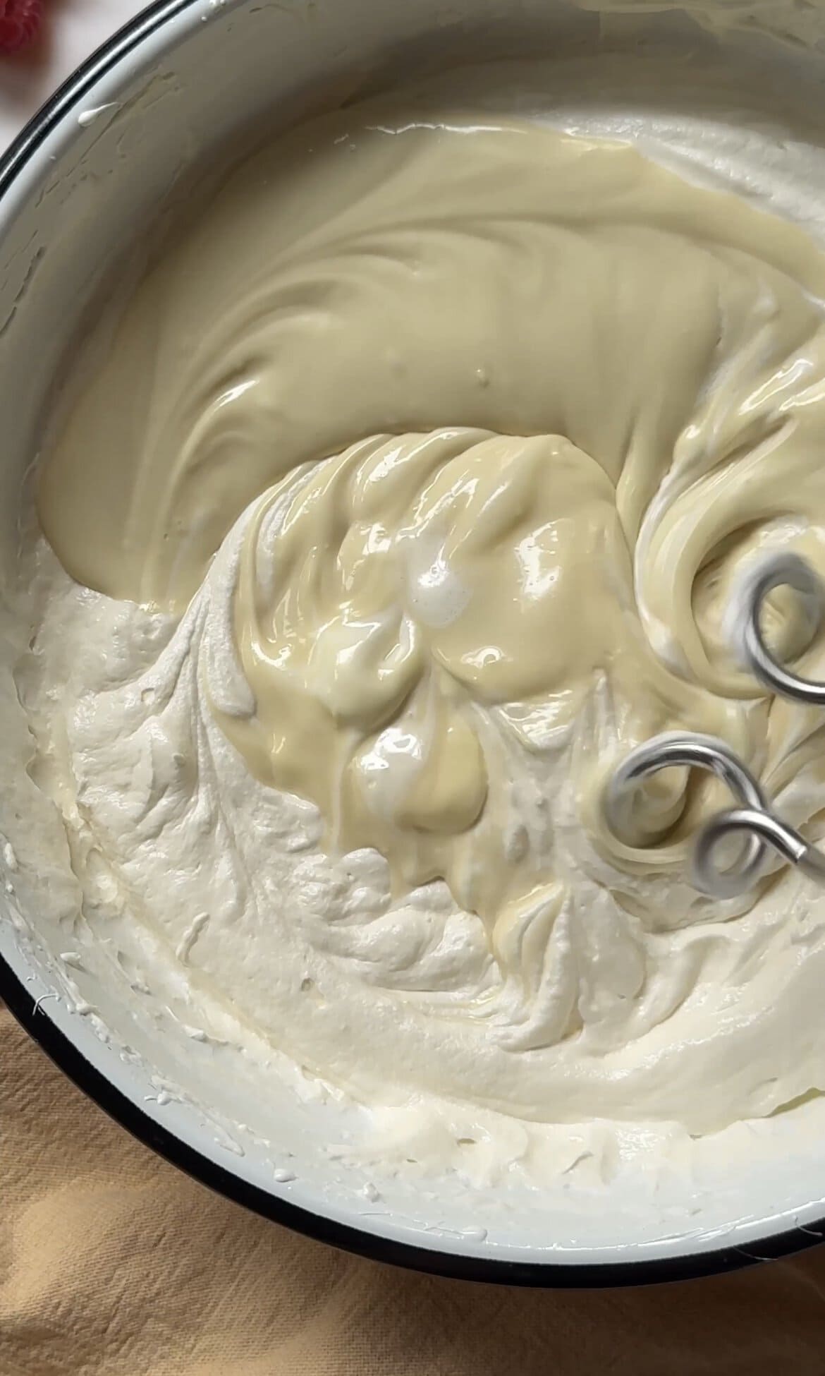 beating melted white chocolate into the buttercream.