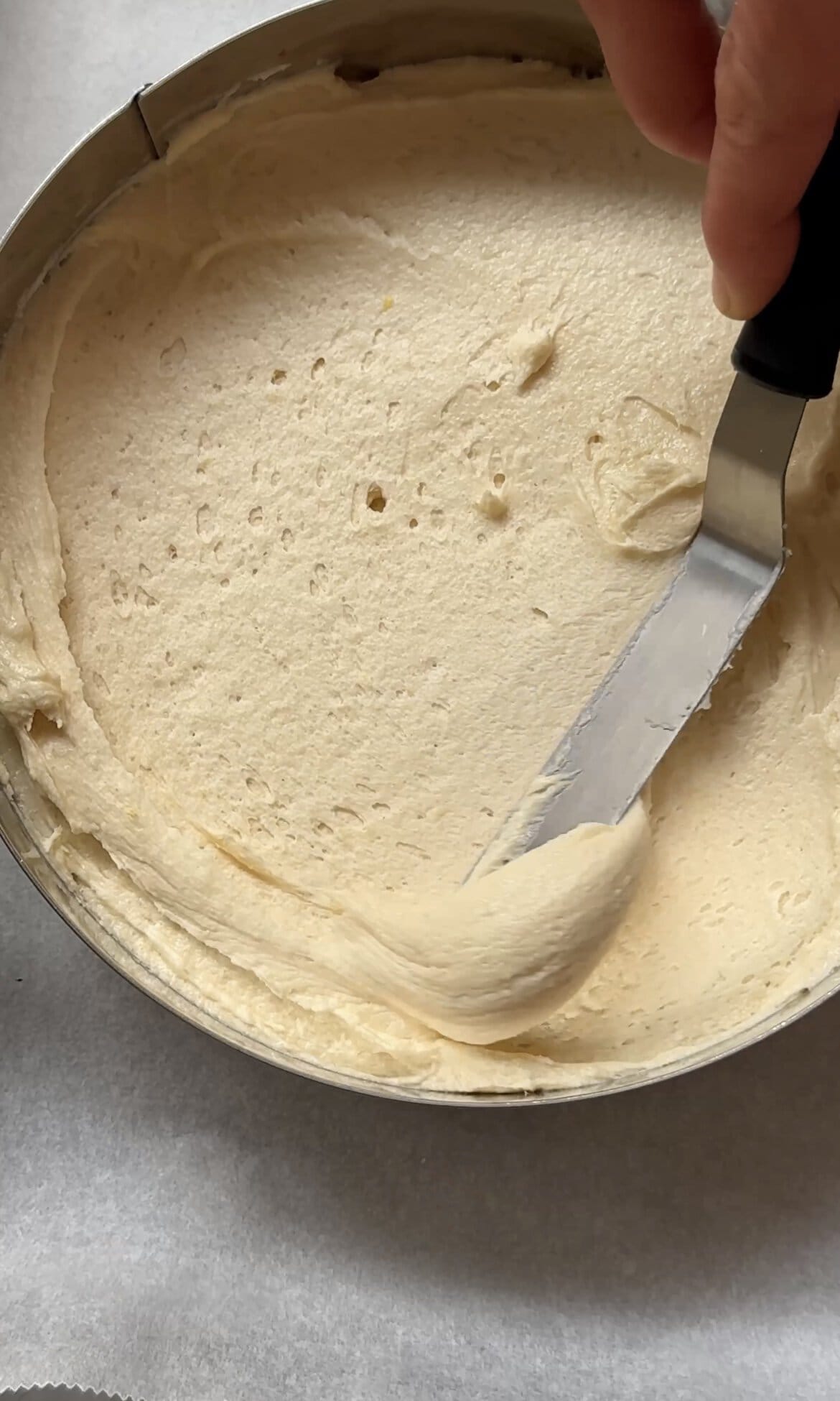 smoothing cake batter into the tins.