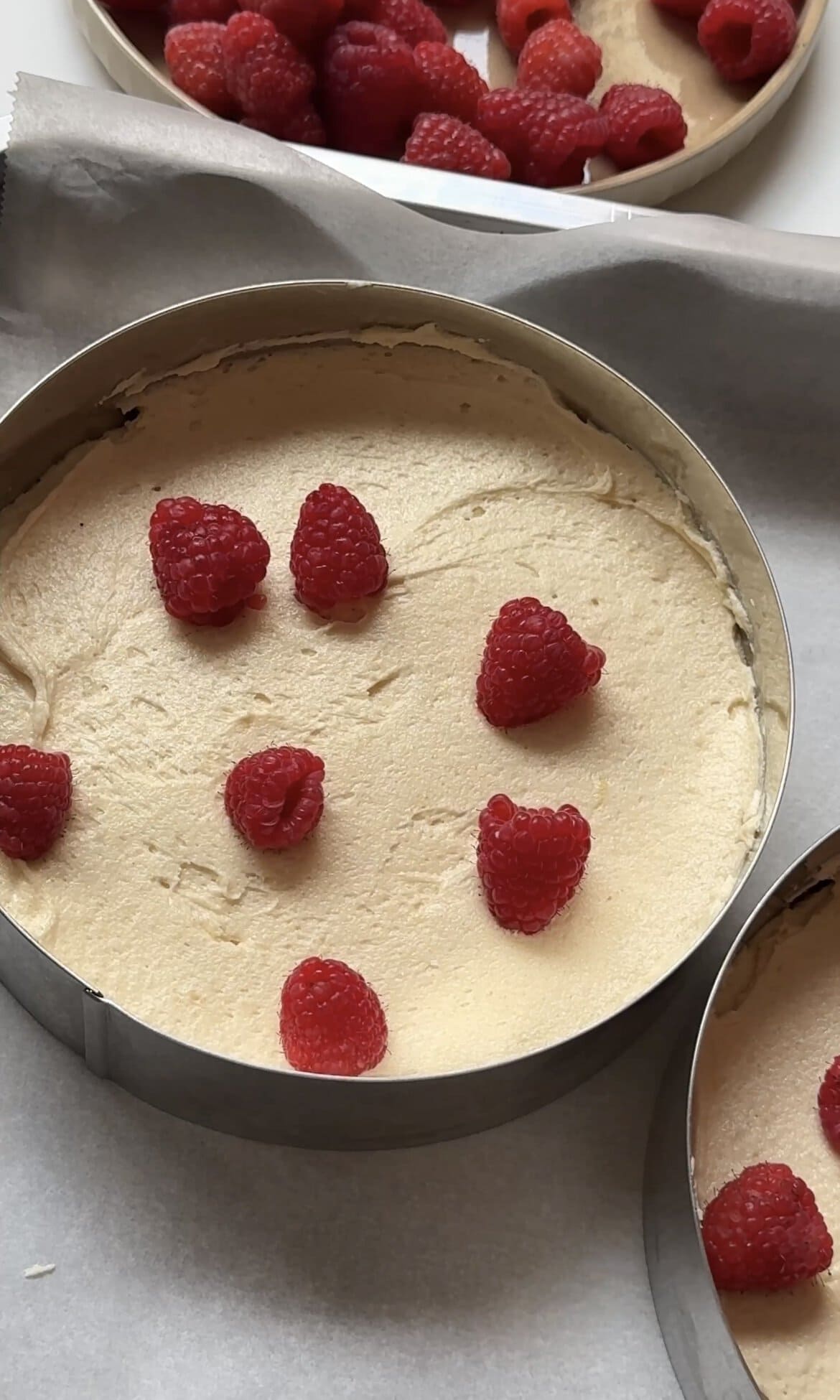 adding raspberries into the cake batter.