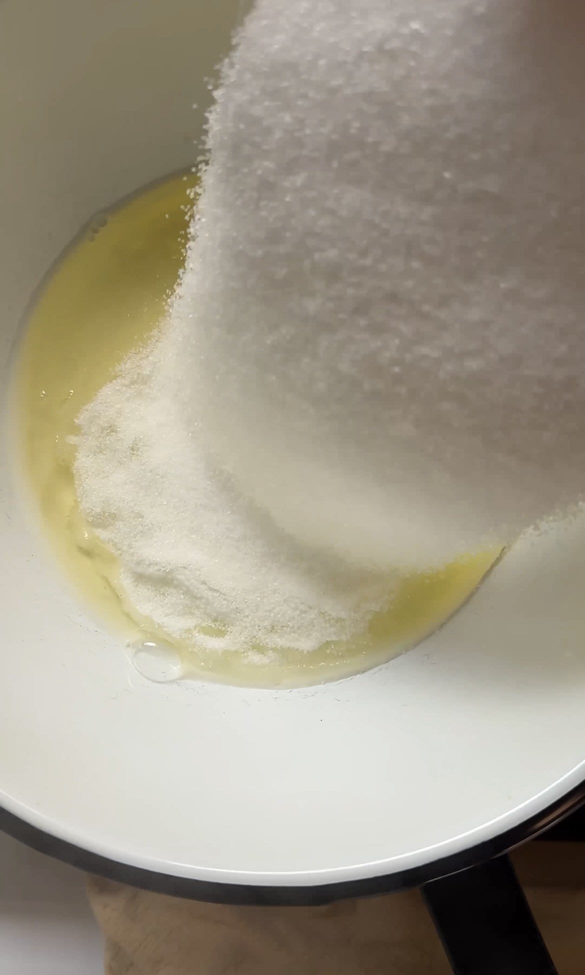 adding sugar to egg whites.