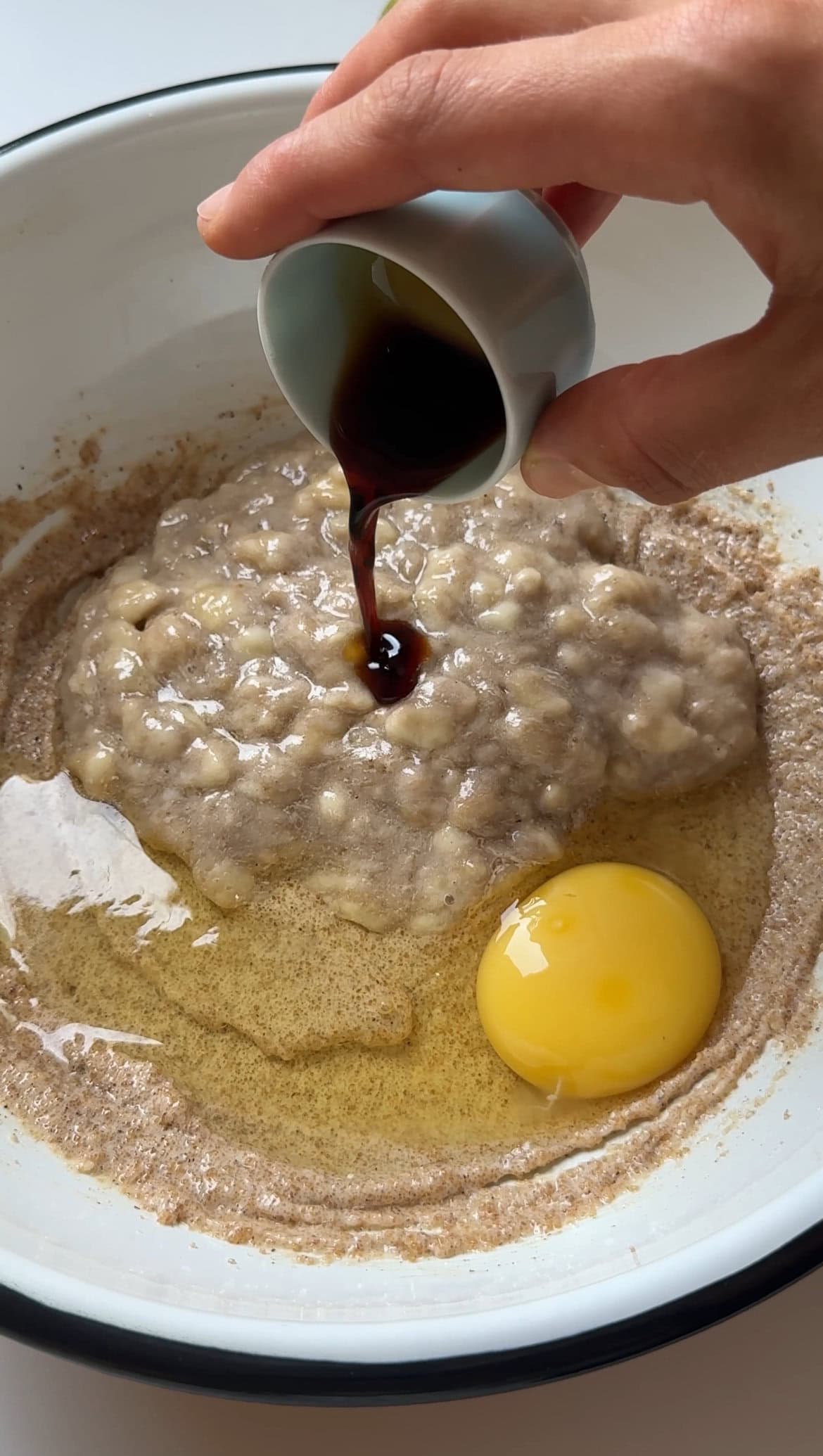 adding vanilla paste to the banana muffins batter.