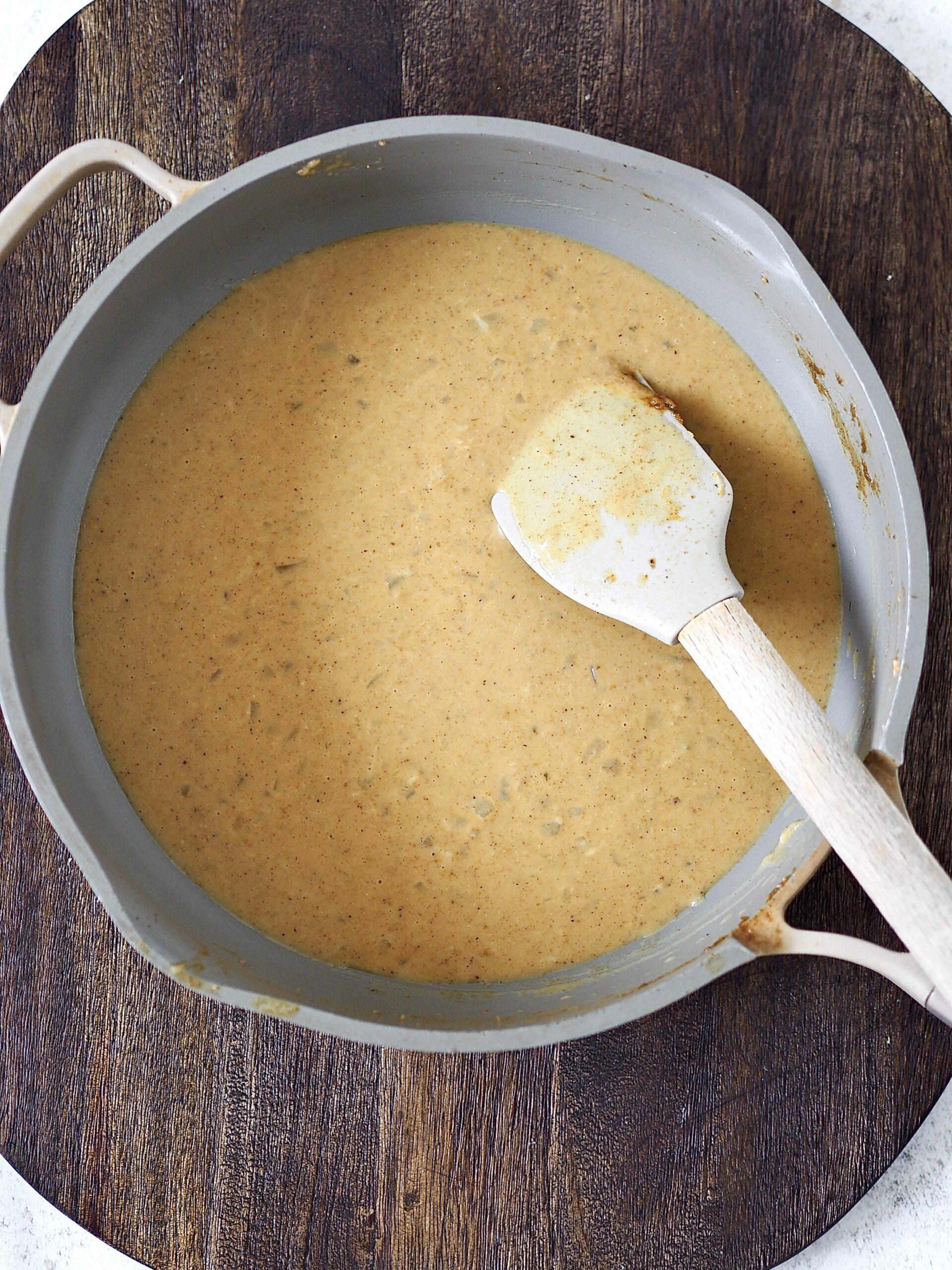 Japanese curry sauce being made in a grey frying pan. 