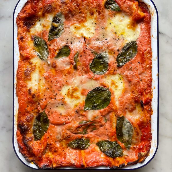 Bake courgette lasagne in a falconware baking dish topped with basil leaves.