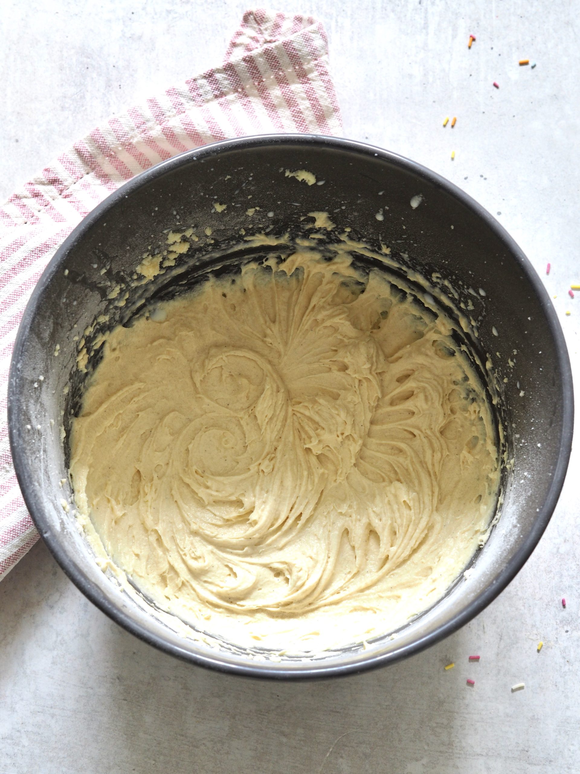 Cake batter in a metal bowl.