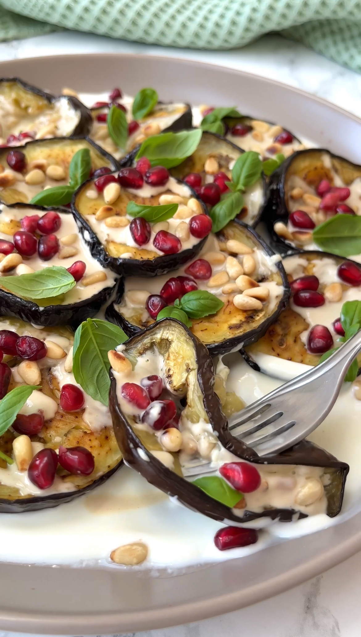 a fork scooping aubergine salad