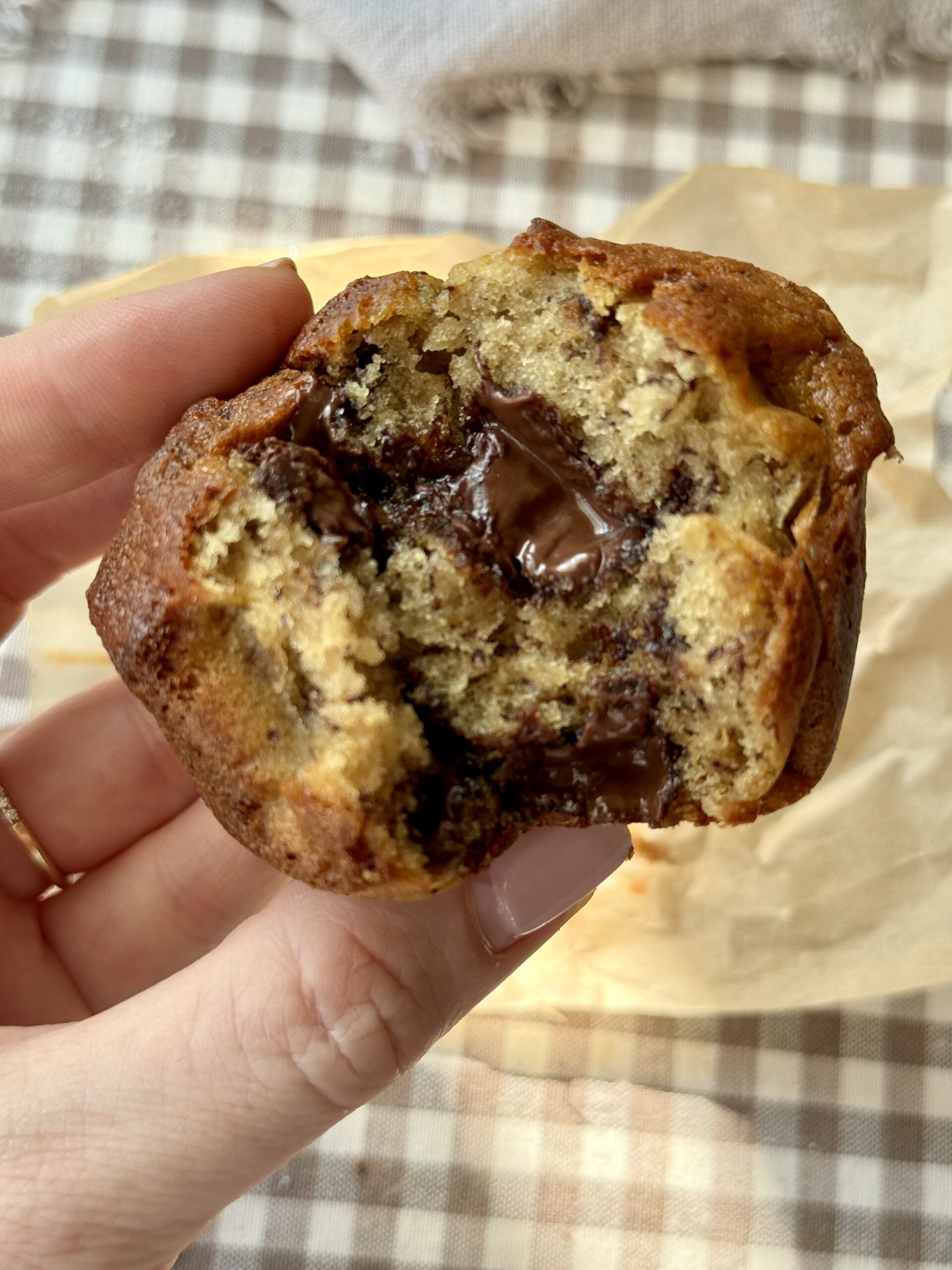 woman holding banana chocolate chunk muffin