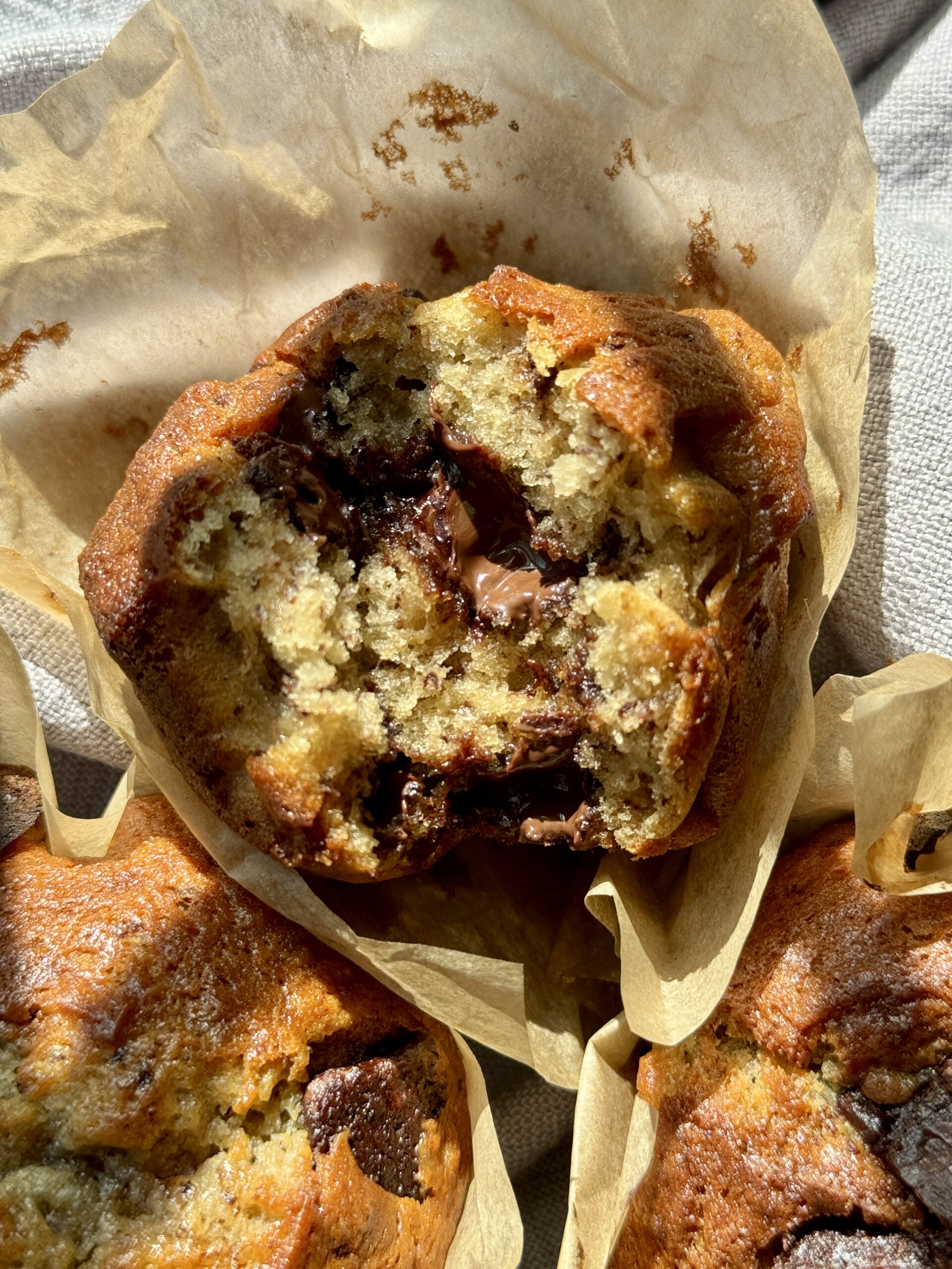 woman holding banana chocolate chunk muffin