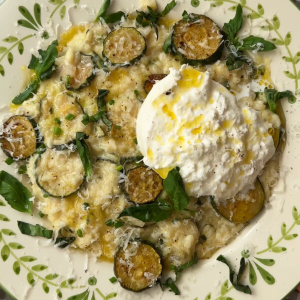 creamy zucchini risotto in a bowl with mozzarella on top