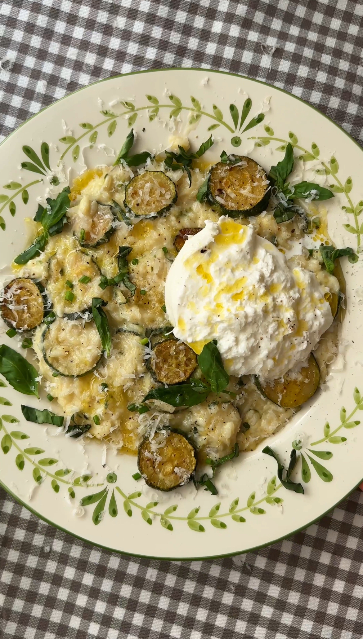 creamy zucchini risotto in a bowl with mozzarella on top