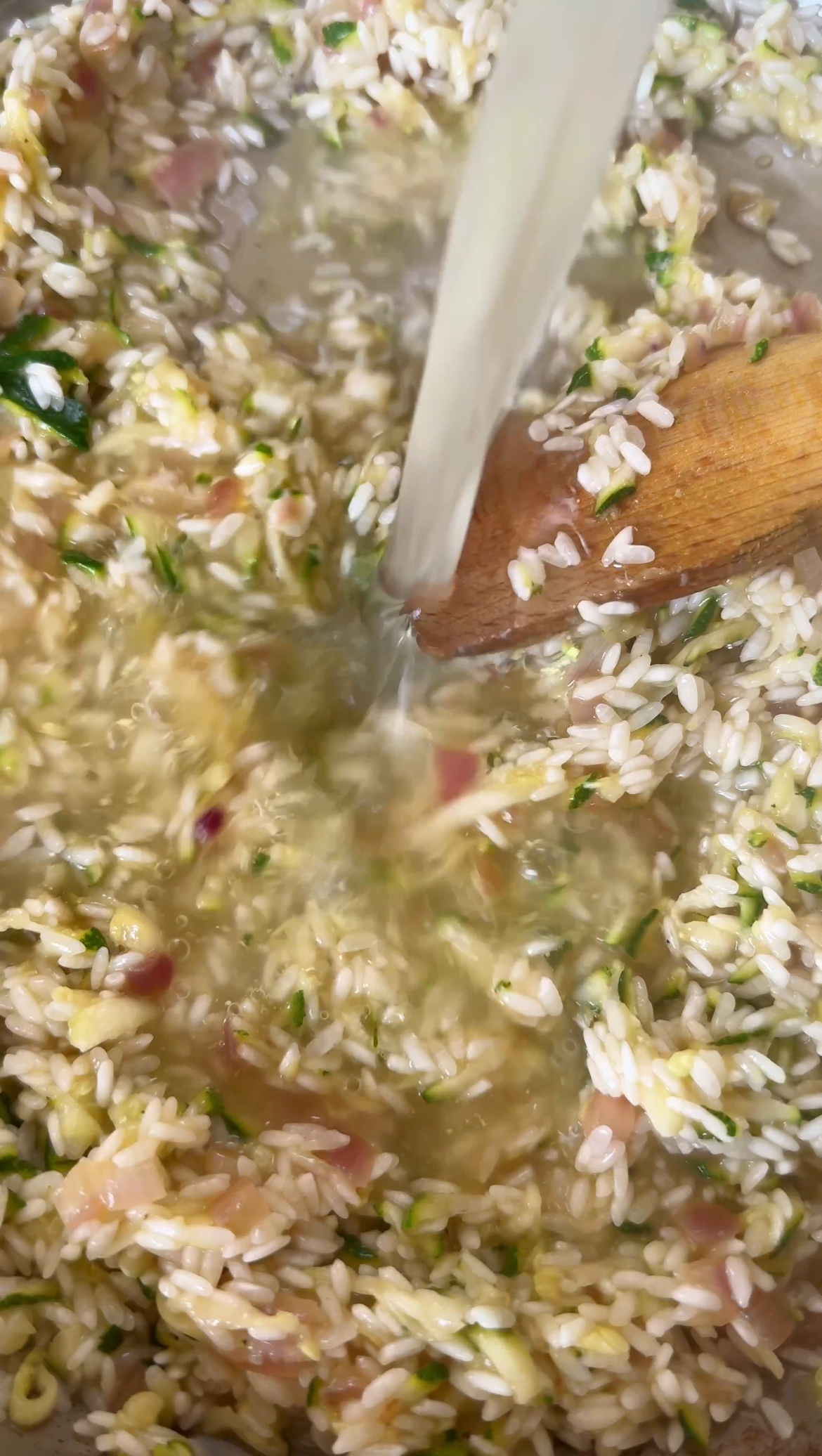 adding stock to risotto