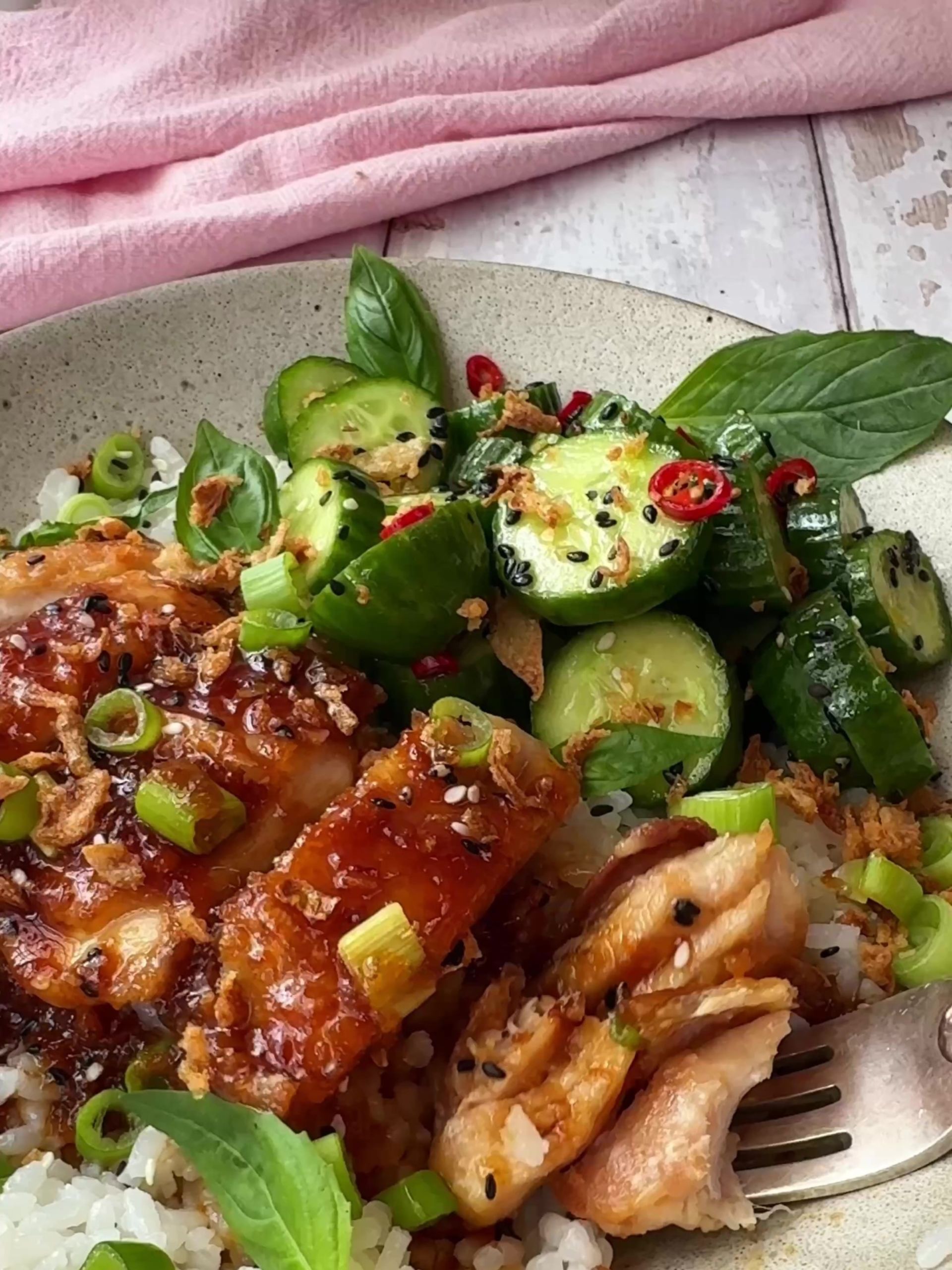 Garlic and Soy chicken in a bowl with rice and cucumber salad