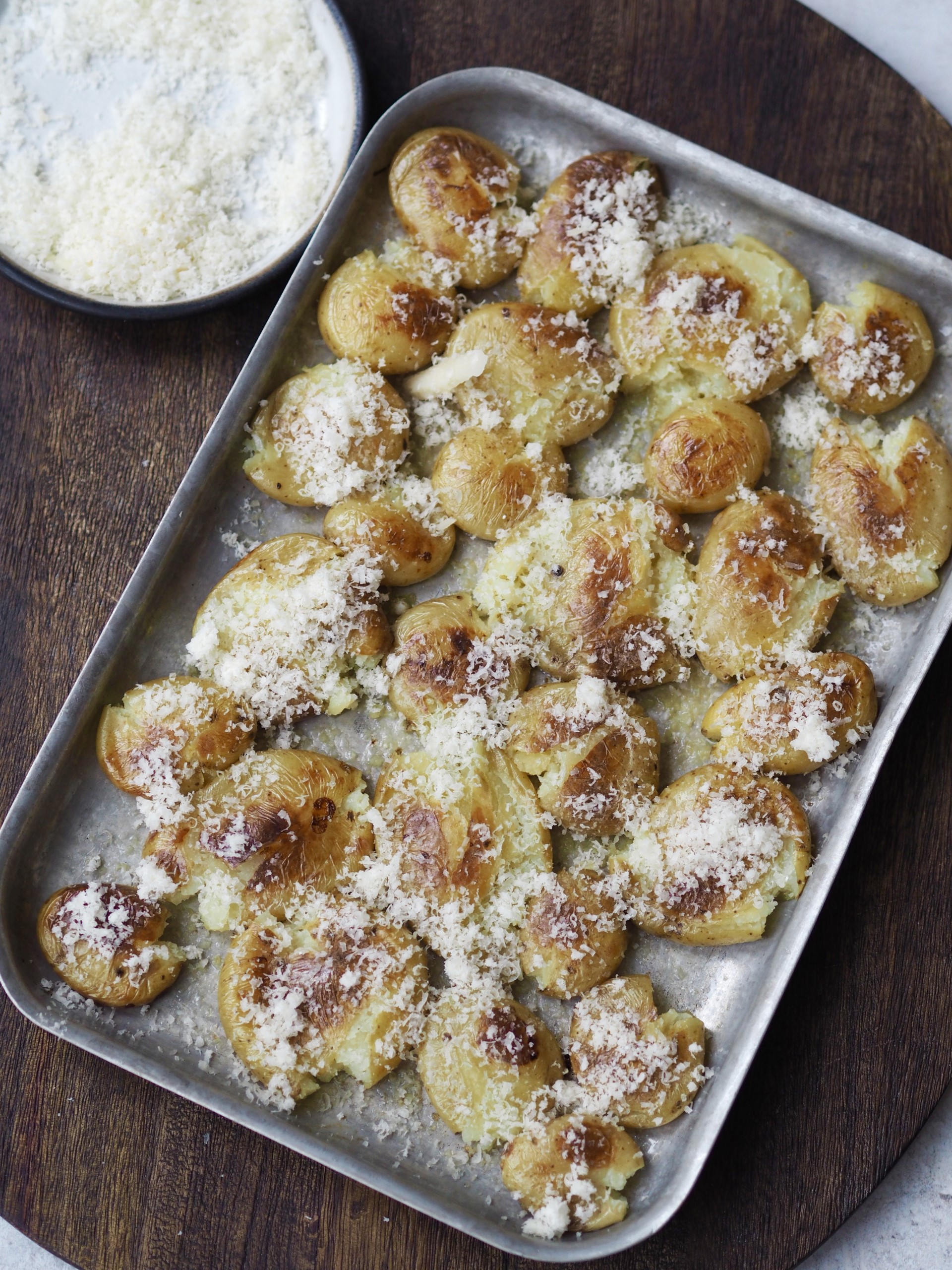 Sprinkling the potatoes with Parmesan