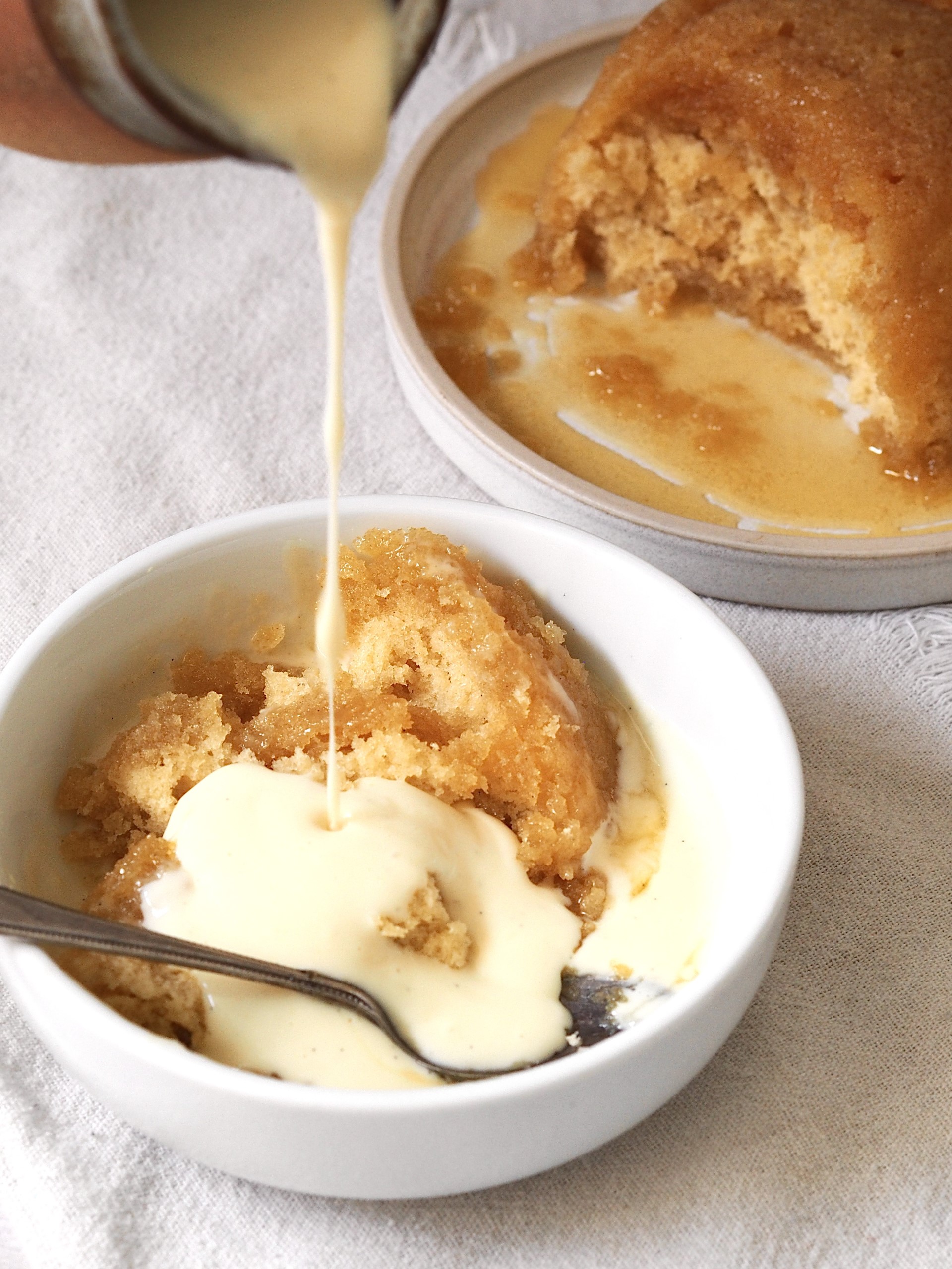 Pouring custard over Microwave Syrup Sponge